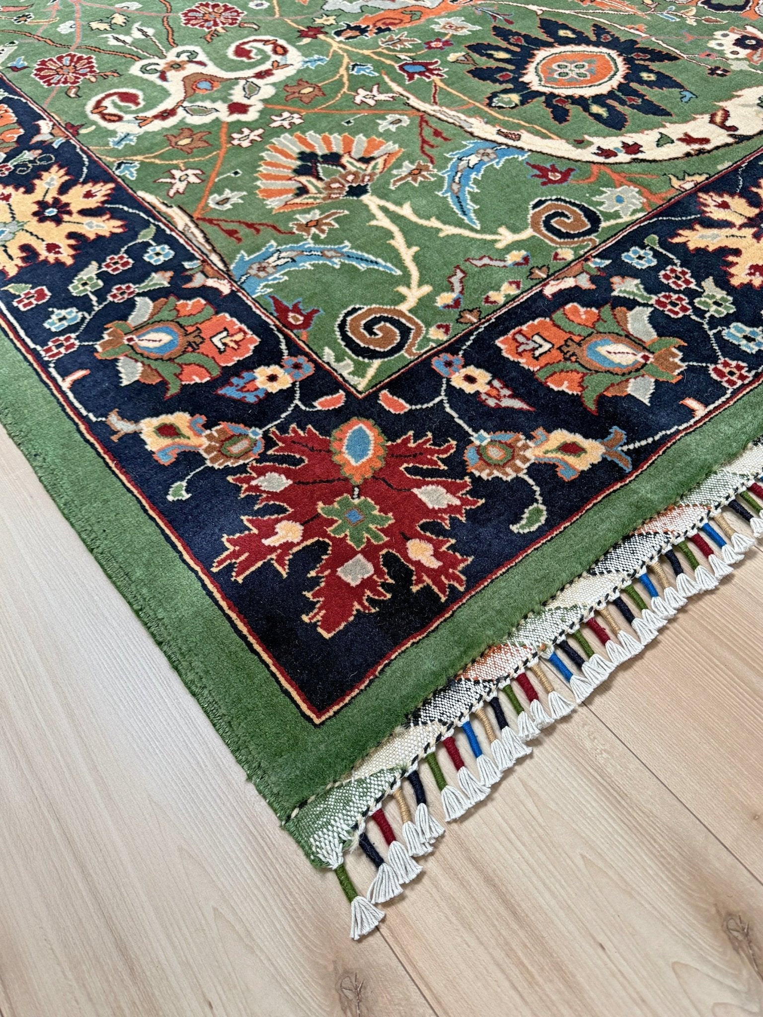 Brand new 9x12 Persian sickle leaf rug with verdant green, navy, and crimson hues, available at the best rug shop in San Mateo, SF Bay Area. Handwoven with intricate floral and vine patterns, perfect for a bedroom, living room, or dining space. High-quality wool rug with rich character and timeless elegance. Free shipping available.