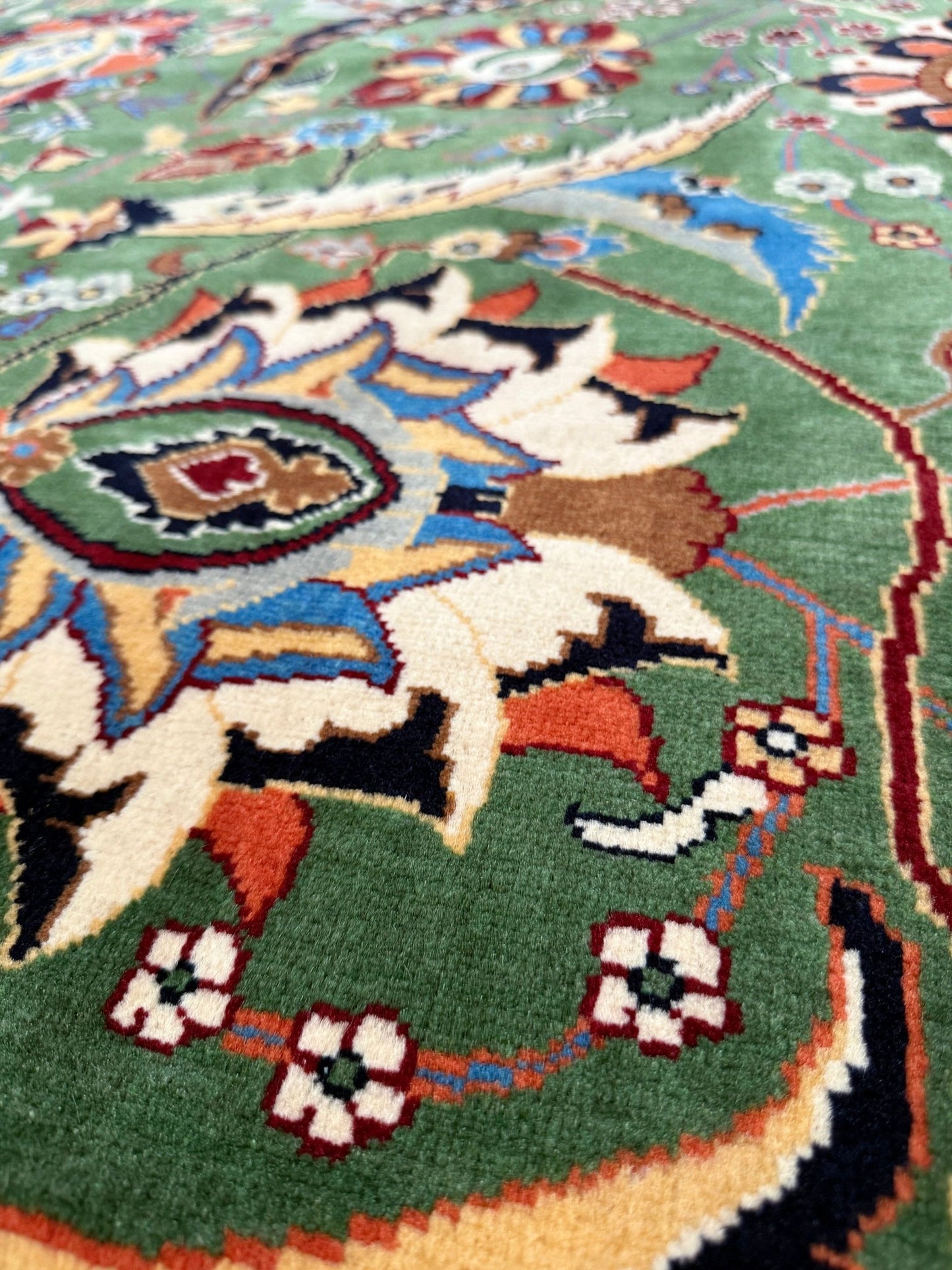 Brand new 9x12 Persian sickle leaf rug with verdant green, navy, and crimson hues, available at the best rug shop in San Mateo, SF Bay Area. Handwoven with intricate floral and vine patterns, perfect for a bedroom, living room, or dining space. High-quality wool rug with rich character and timeless elegance. Free shipping available.