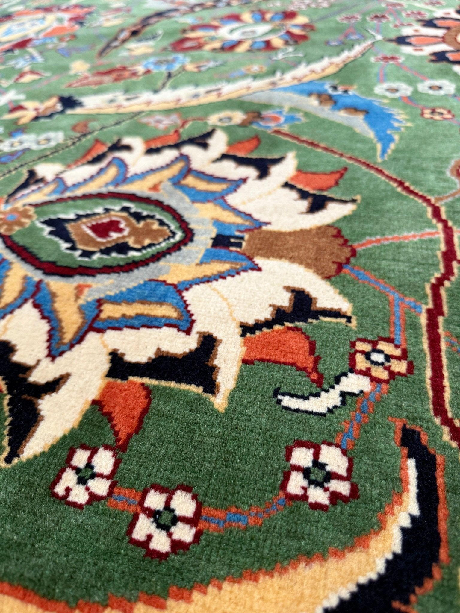 Brand new 9x12 Persian sickle leaf rug with verdant green, navy, and crimson hues, available at the best rug shop in San Mateo, SF Bay Area. Handwoven with intricate floral and vine patterns, perfect for a bedroom, living room, or dining space. High-quality wool rug with rich character and timeless elegance. Free shipping available.