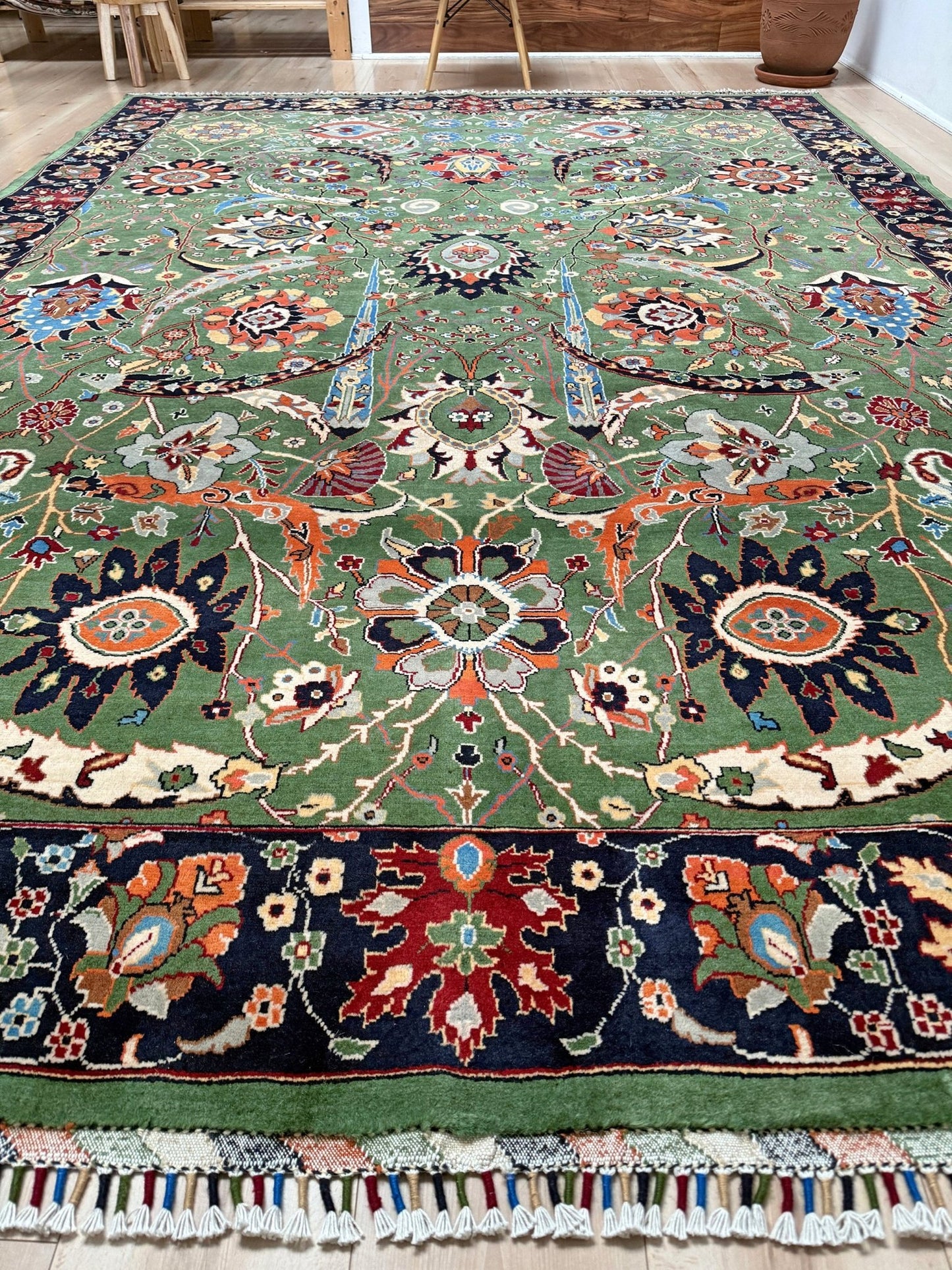 Brand new 9x12 Persian sickle leaf rug with verdant green, navy, and crimson hues, available at the best rug shop in San Mateo, SF Bay Area. Handwoven with intricate floral and vine patterns, perfect for a bedroom, living room, or dining space. High-quality wool rug with rich character and timeless elegance. Free shipping available.