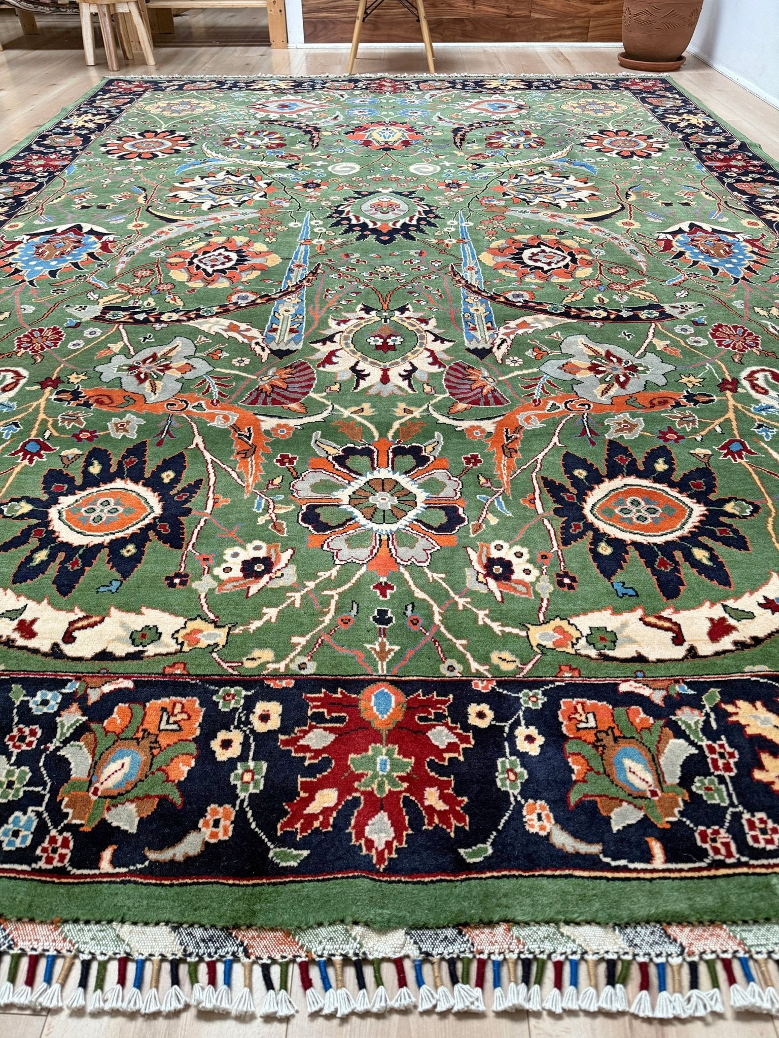 Brand new 9x12 Persian sickle leaf rug with verdant green, navy, and crimson hues, available at the best rug shop in San Mateo, SF Bay Area. Handwoven with intricate floral and vine patterns, perfect for a bedroom, living room, or dining space. High-quality wool rug with rich character and timeless elegance. Free shipping available.