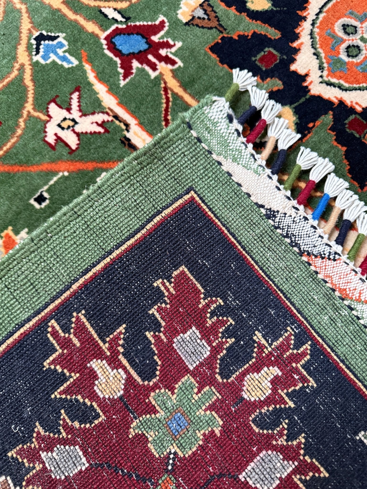 Brand new 9x12 Persian sickle leaf rug with verdant green, navy, and crimson hues, available at the best rug shop in San Mateo, SF Bay Area. Handwoven with intricate floral and vine patterns, perfect for a bedroom, living room, or dining space. High-quality wool rug with rich character and timeless elegance. Free shipping available.