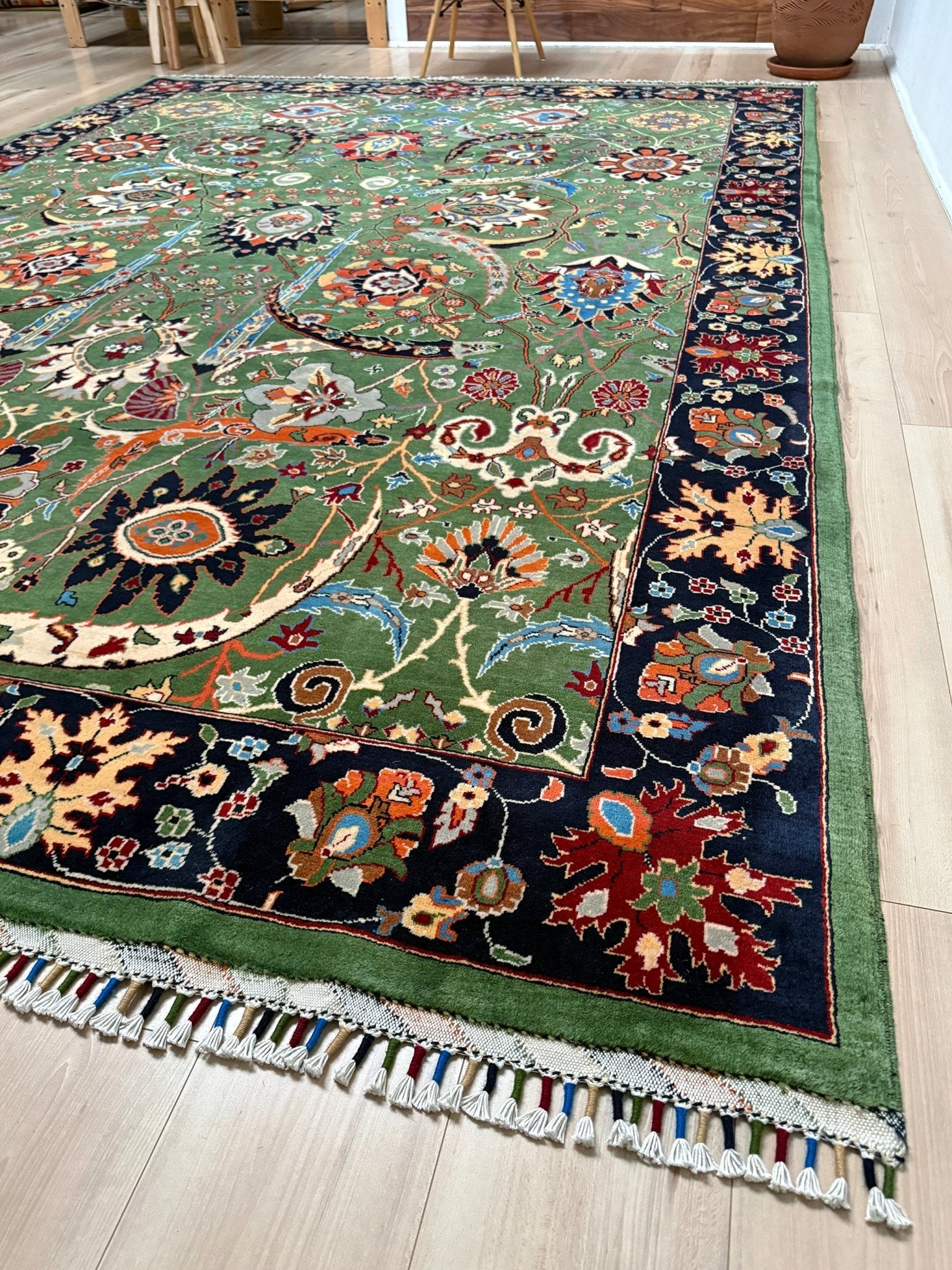 Brand new 9x12 Persian sickle leaf rug with verdant green, navy, and crimson hues, available at the best rug shop in San Mateo, SF Bay Area. Handwoven with intricate floral and vine patterns, perfect for a bedroom, living room, or dining space. High-quality wool rug with rich character and timeless elegance. Free shipping available.