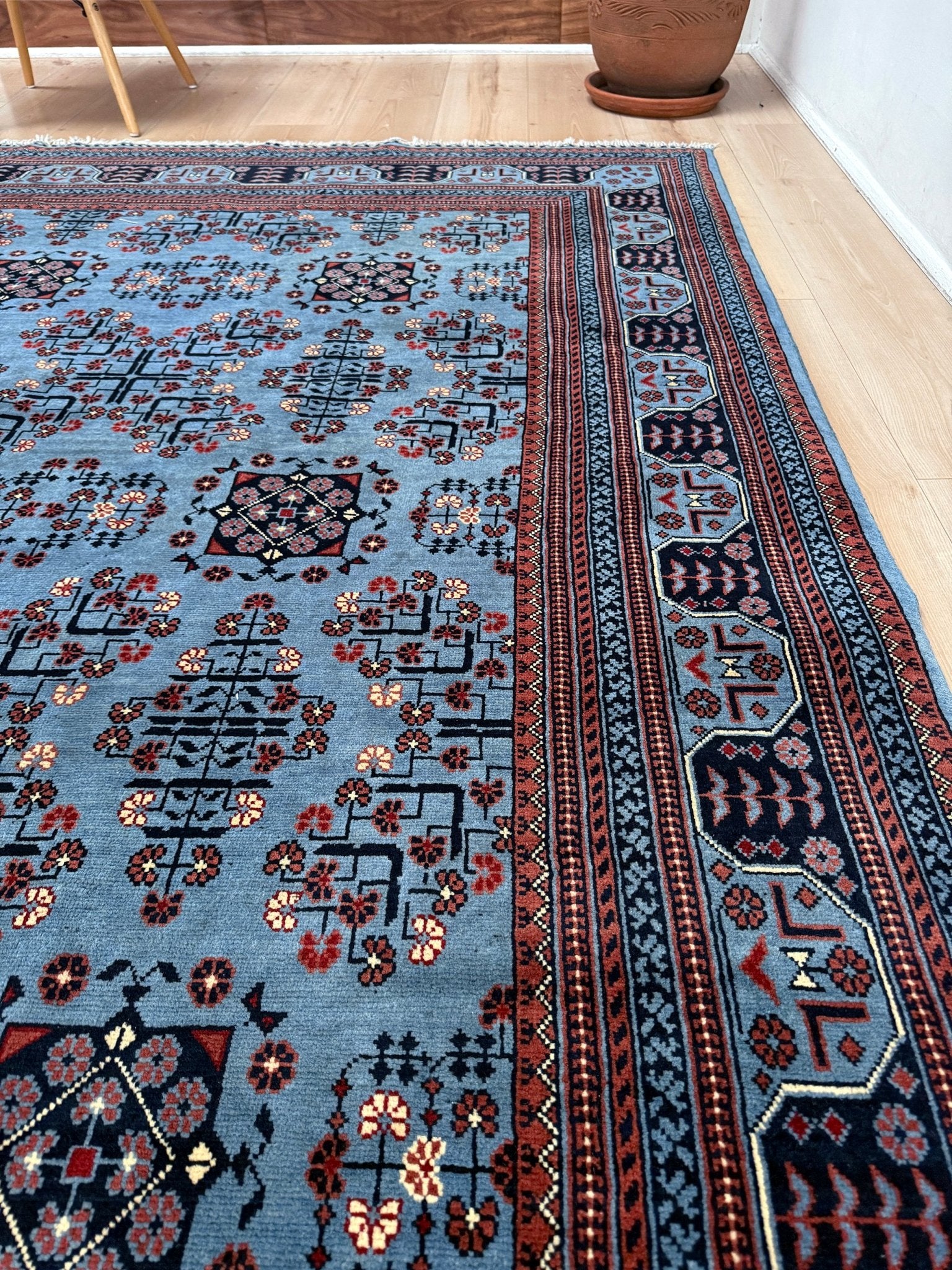 9x12 Handmade Turkmen rug with a baby blue ground, featuring traditional geometric motifs in brown, midnight blue, terracotta crafted from silky Merino wool with a luxurious sheen, available with free shipping from the best handmade rug shop Burlingame CA San Francisco Bay Area.