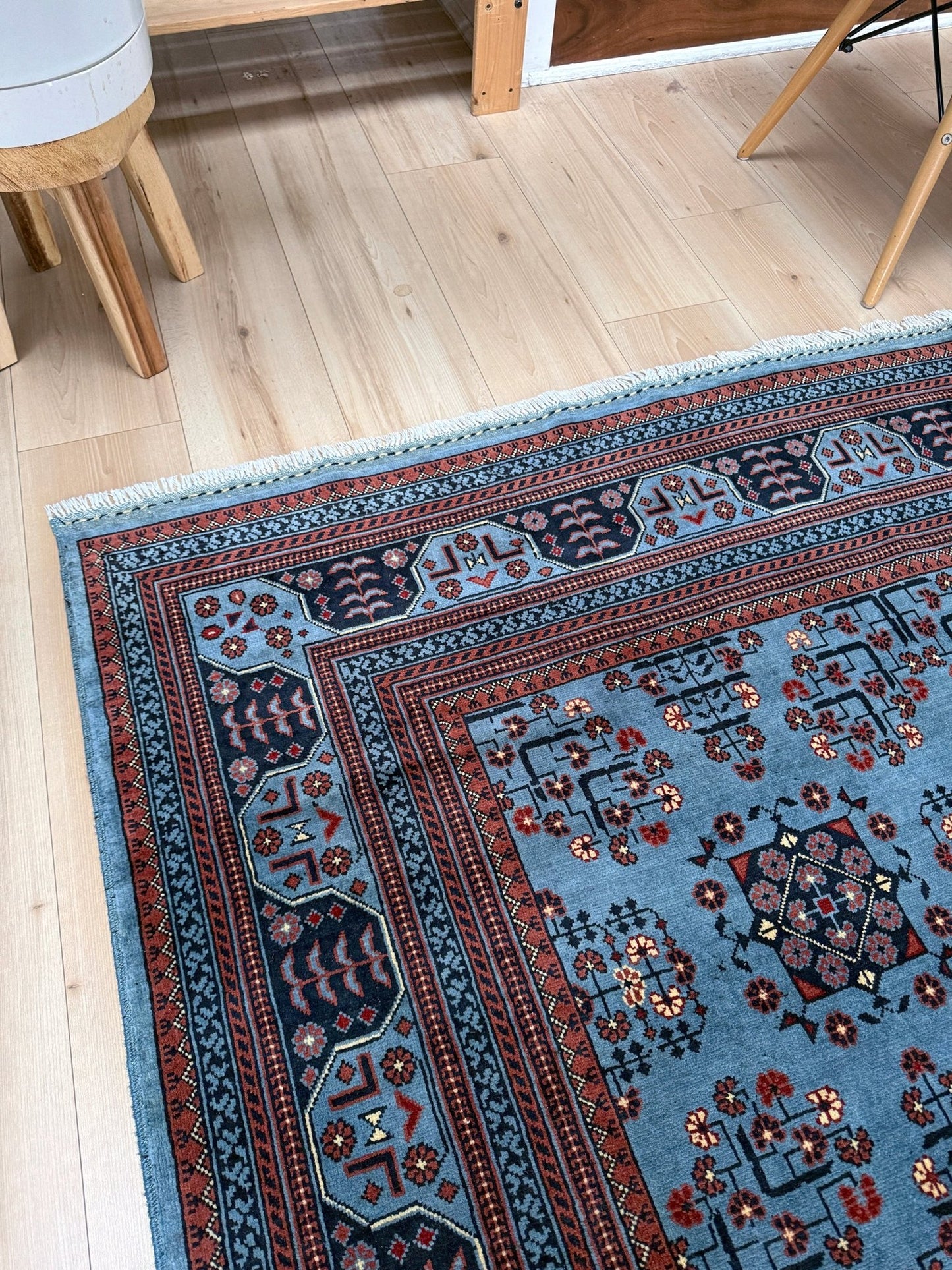 9x12 Handmade Turkmen rug with a baby blue ground, featuring traditional geometric motifs in brown, midnight blue, terracotta crafted from silky Merino wool with a luxurious sheen, available with free shipping from the best handmade rug shop Burlingame CA San Francisco Bay Area.