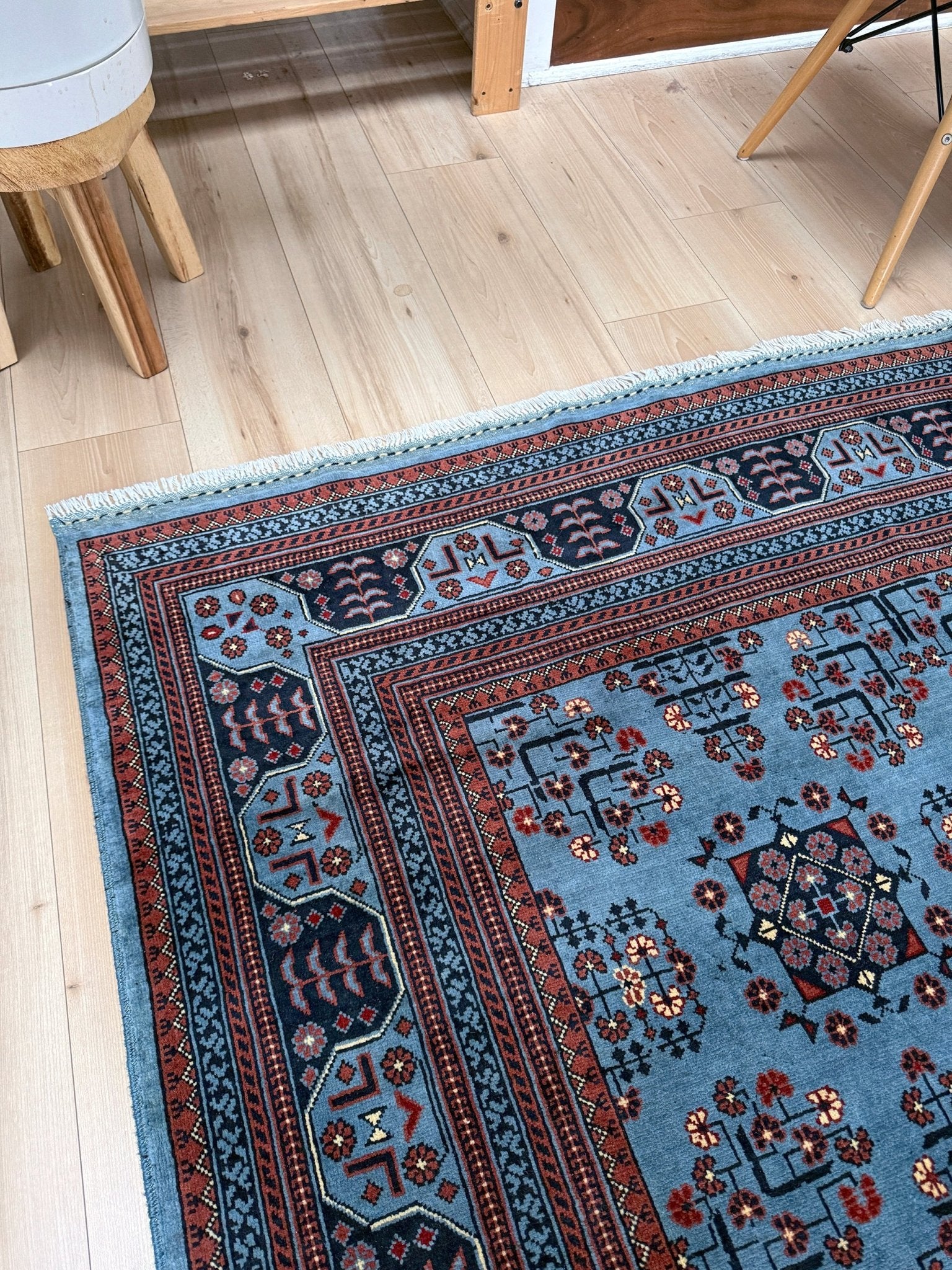 9x12 Handmade Turkmen rug with a baby blue ground, featuring traditional geometric motifs in brown, midnight blue, terracotta crafted from silky Merino wool with a luxurious sheen, available with free shipping from the best handmade rug shop Burlingame CA San Francisco Bay Area.