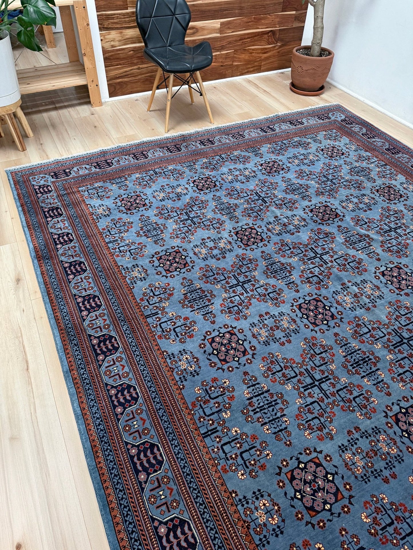 9x12 Handmade Turkmen rug with a baby blue ground, featuring traditional geometric motifs in brown, midnight blue, terracotta crafted from silky Merino wool with a luxurious sheen, available with free shipping from the best handmade rug shop Burlingame CA San Francisco Bay Area.