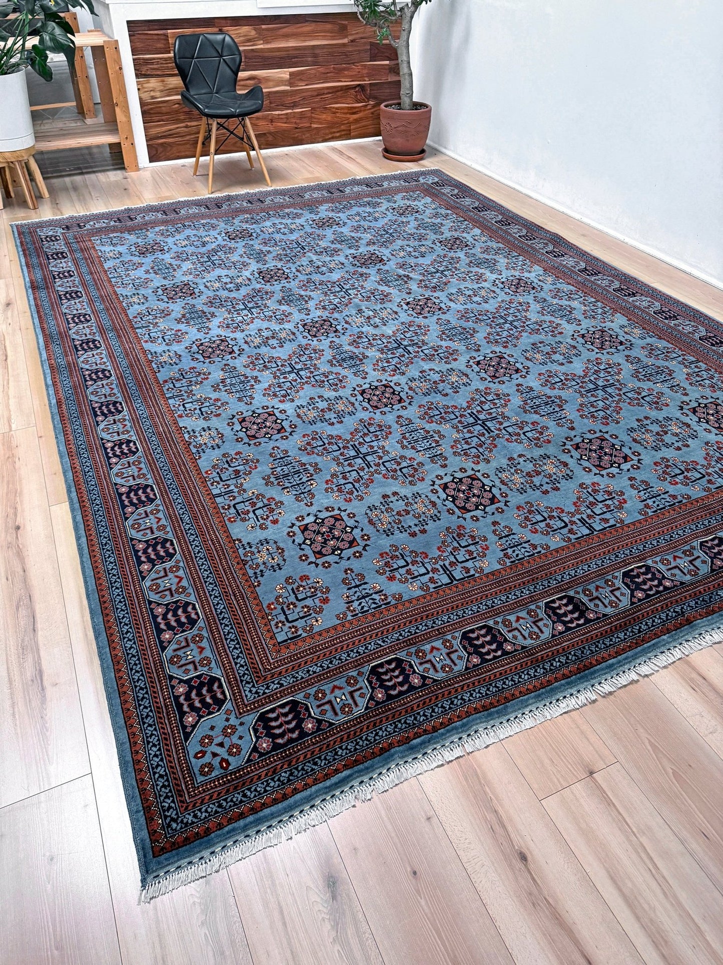 9x12 Handmade Turkmen rug with a baby blue ground, featuring traditional geometric motifs in brown, midnight blue, terracotta crafted from silky Merino wool with a luxurious sheen, available with free shipping from the best handmade rug shop Burlingame CA San Francisco Bay Area.