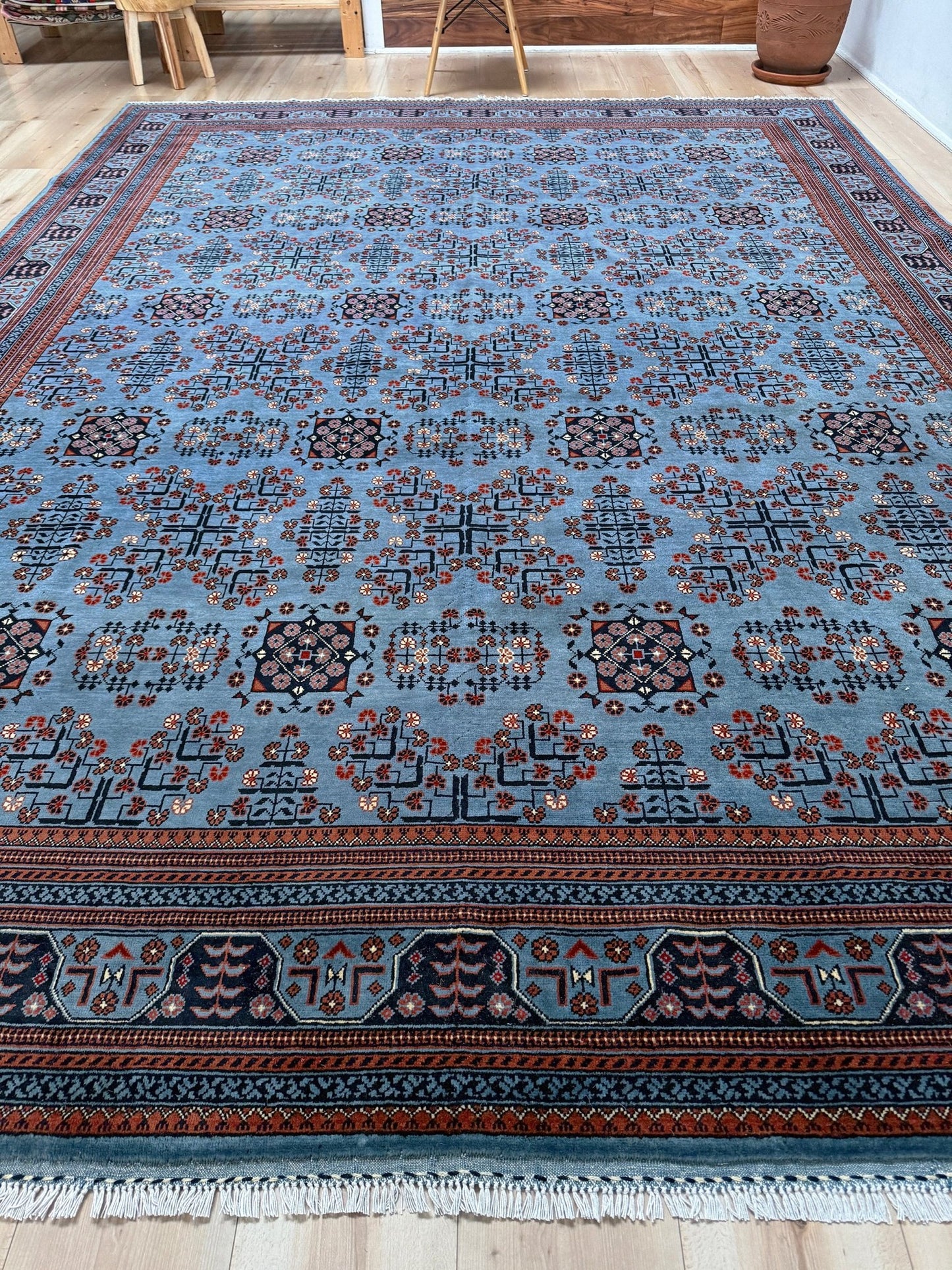 9x12 Handmade Turkmen rug with a baby blue ground, featuring traditional geometric motifs in brown, midnight blue, terracotta crafted from silky Merino wool with a luxurious sheen, available with free shipping from the best handmade rug shop Burlingame CA San Francisco Bay Area.