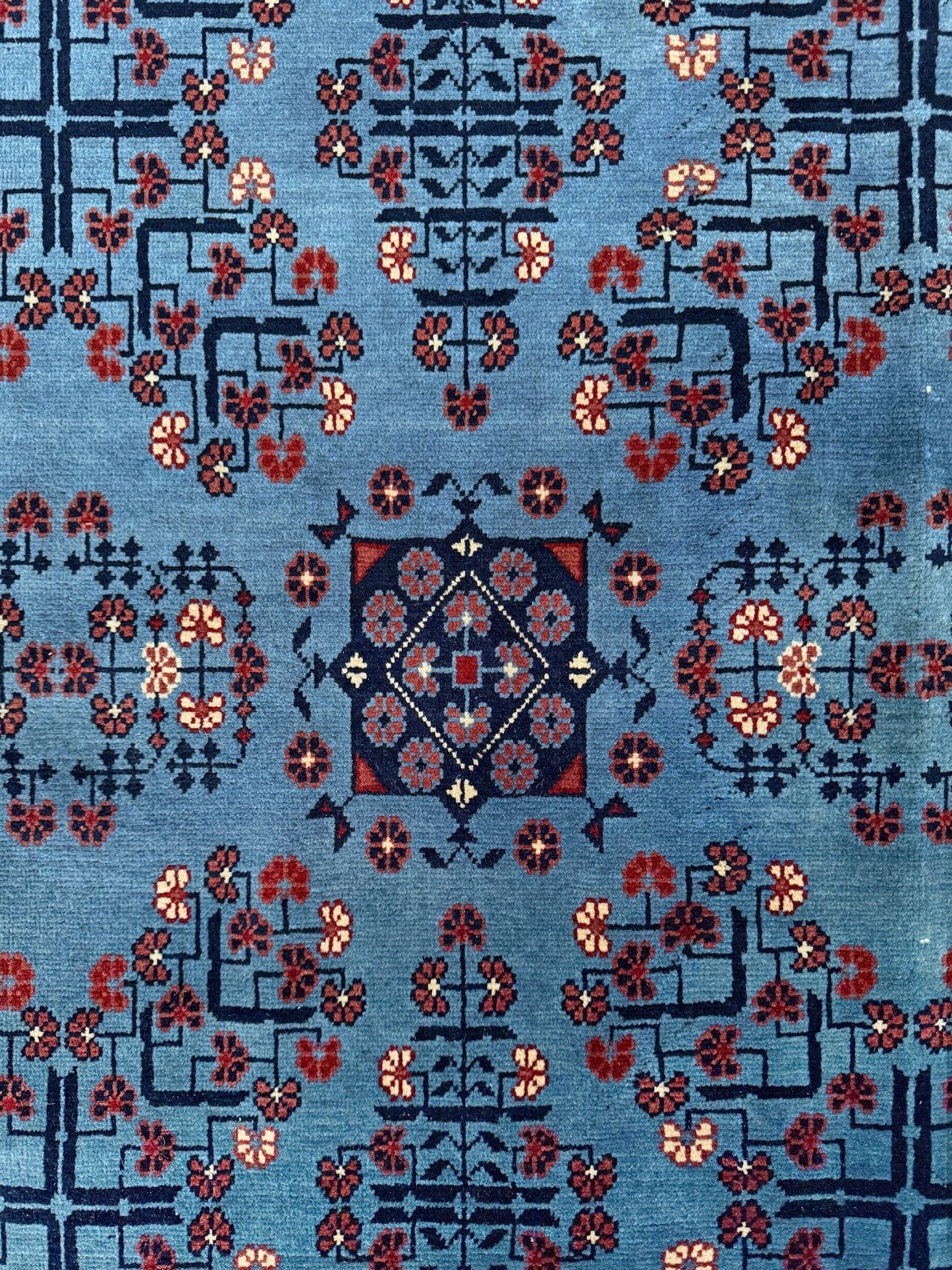 9x12 Handmade Turkmen rug with a baby blue ground, featuring traditional geometric motifs in brown, midnight blue, terracotta crafted from silky Merino wool with a luxurious sheen, available with free shipping from the best handmade rug shop Burlingame CA San Francisco Bay Area.