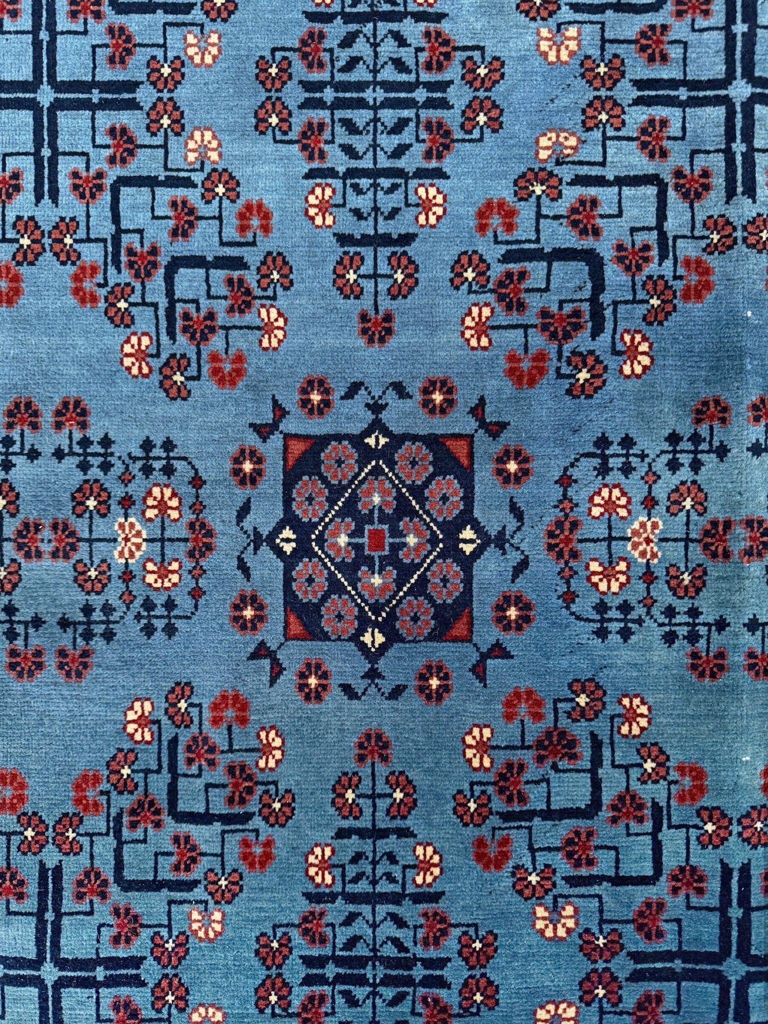 9x12 Handmade Turkmen rug with a baby blue ground, featuring traditional geometric motifs in brown, midnight blue, terracotta crafted from silky Merino wool with a luxurious sheen, available with free shipping from the best handmade rug shop Burlingame CA San Francisco Bay Area.