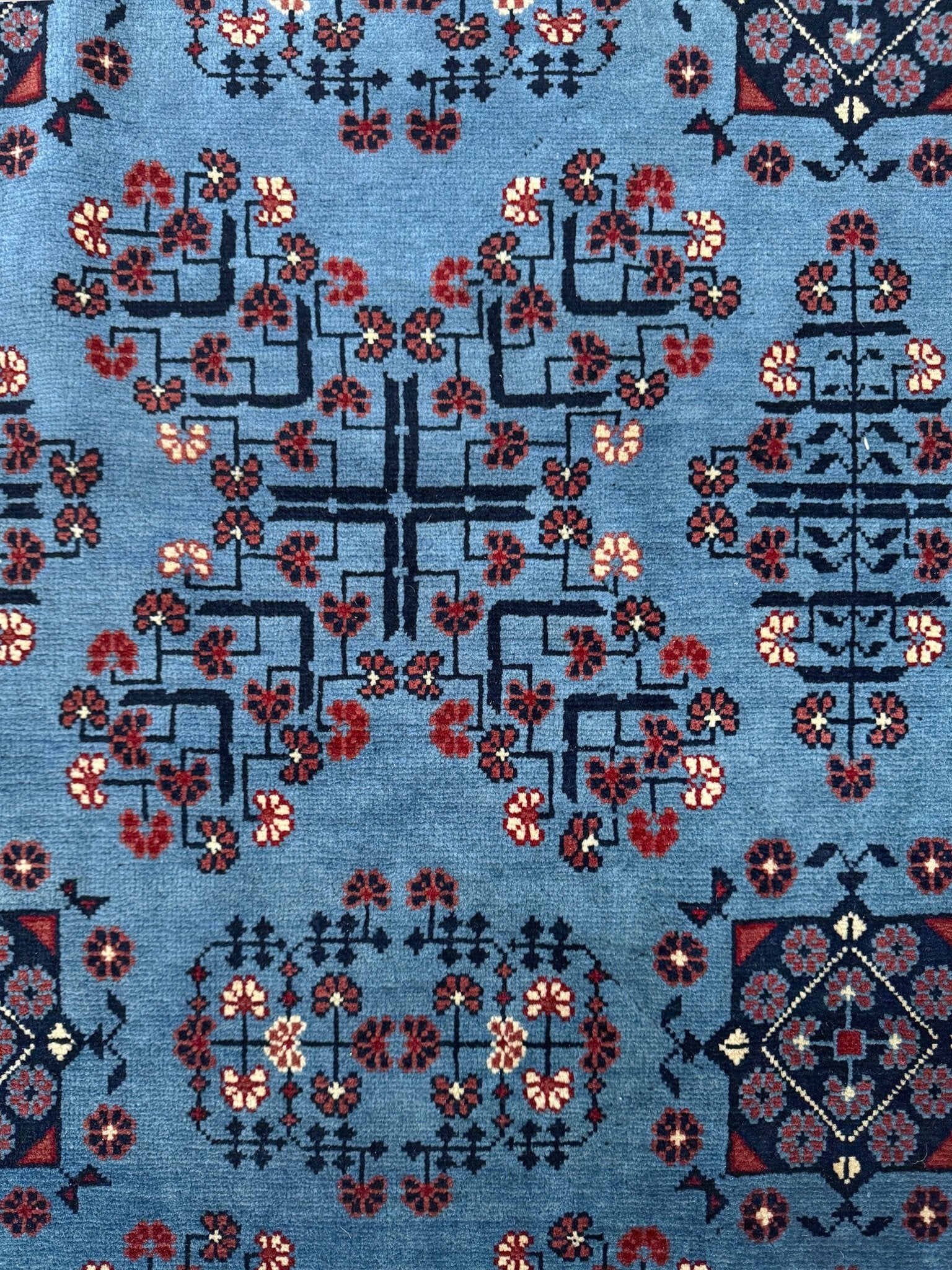 9x12 Handmade Turkmen rug with a baby blue ground, featuring traditional geometric motifs in brown, midnight blue, terracotta crafted from silky Merino wool with a luxurious sheen, available with free shipping from the best handmade rug shop Burlingame CA San Francisco Bay Area.