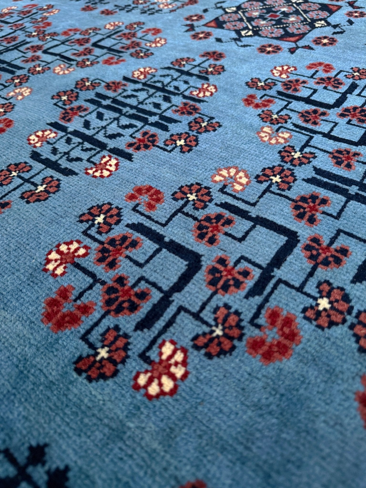 9x12 Handmade Turkmen rug with a baby blue ground, featuring traditional geometric motifs in brown, midnight blue, terracotta crafted from silky Merino wool with a luxurious sheen, available with free shipping from the best handmade rug shop Burlingame CA San Francisco Bay Area.