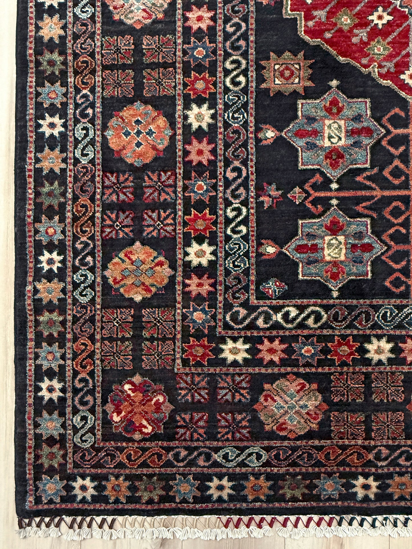 Charcoal Gendje Turkish rug with colorful allover floral medallions, crimson red, sage green, handmade wool 9x12 rug for living room, bedroom from Indigo Rugs Burlingame Bay Area.