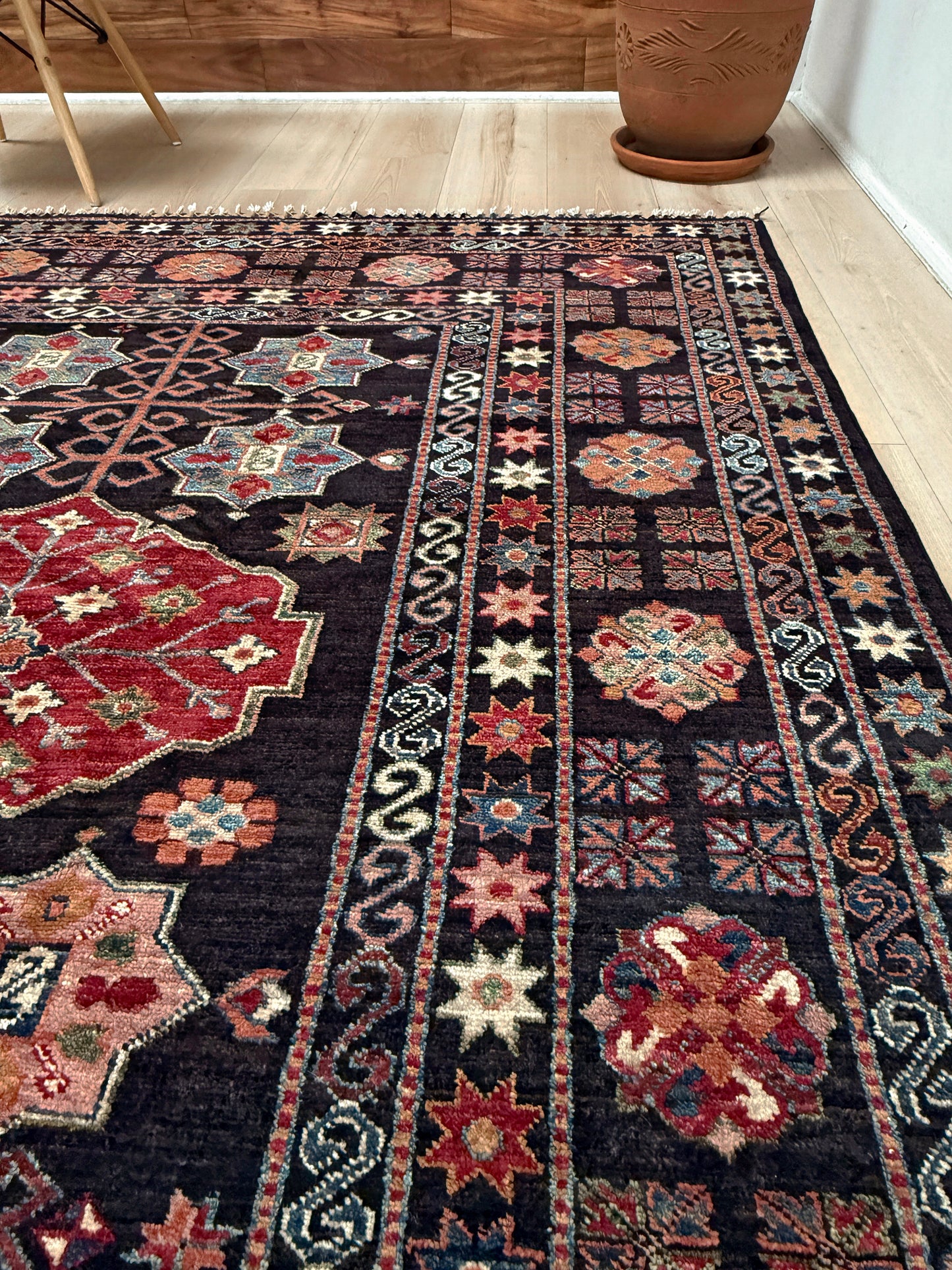 Charcoal Gendje Turkish rug with colorful allover floral medallions, crimson red, sage green, handmade wool 9x12 rug for living room, bedroom from Indigo Rugs Burlingame Bay Area.
