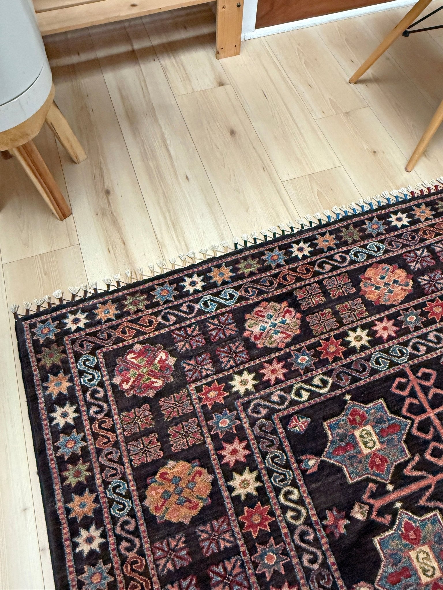 Handmade Turkmen-style 9x12 wool rug with Caucasian-inspired design, rich black, crimson, ivory, and sage hues. Luxury area rug with intricate medallions and floral motifs, perfect for bedroom, living room, or dining room. High-quality craftsmanship from the best rug shop in Burlingame CA, SF Bay Area. Free shipping, timeless character, and elegance for any space.