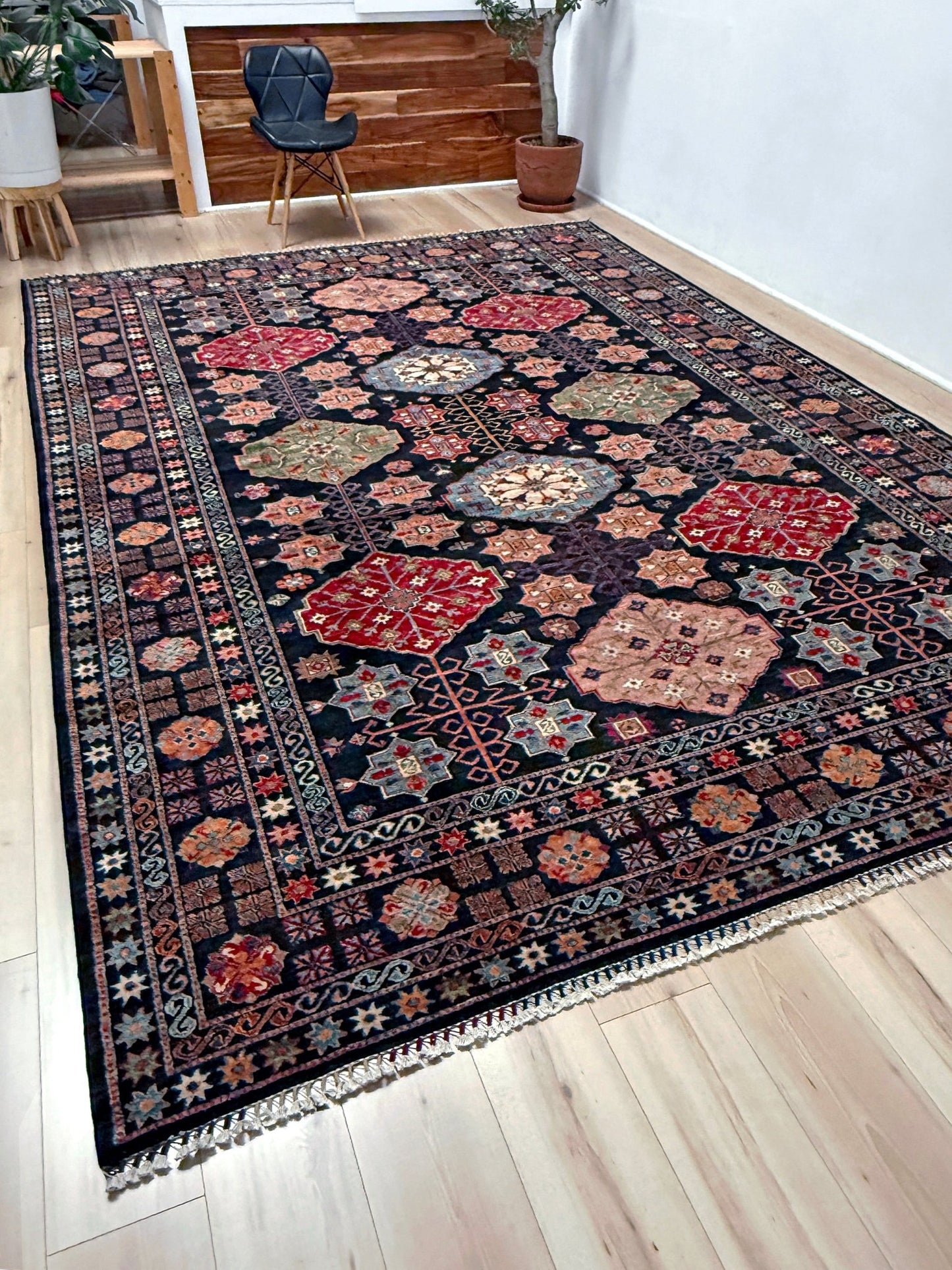 Handmade Turkmen-style 9x12 wool rug with Caucasian-inspired design, rich black, crimson, ivory, and sage hues. Luxury area rug with intricate medallions and floral motifs, perfect for bedroom, living room, or dining room. High-quality craftsmanship from the best rug shop in Burlingame CA, SF Bay Area. Free shipping, timeless character, and elegance for any space.