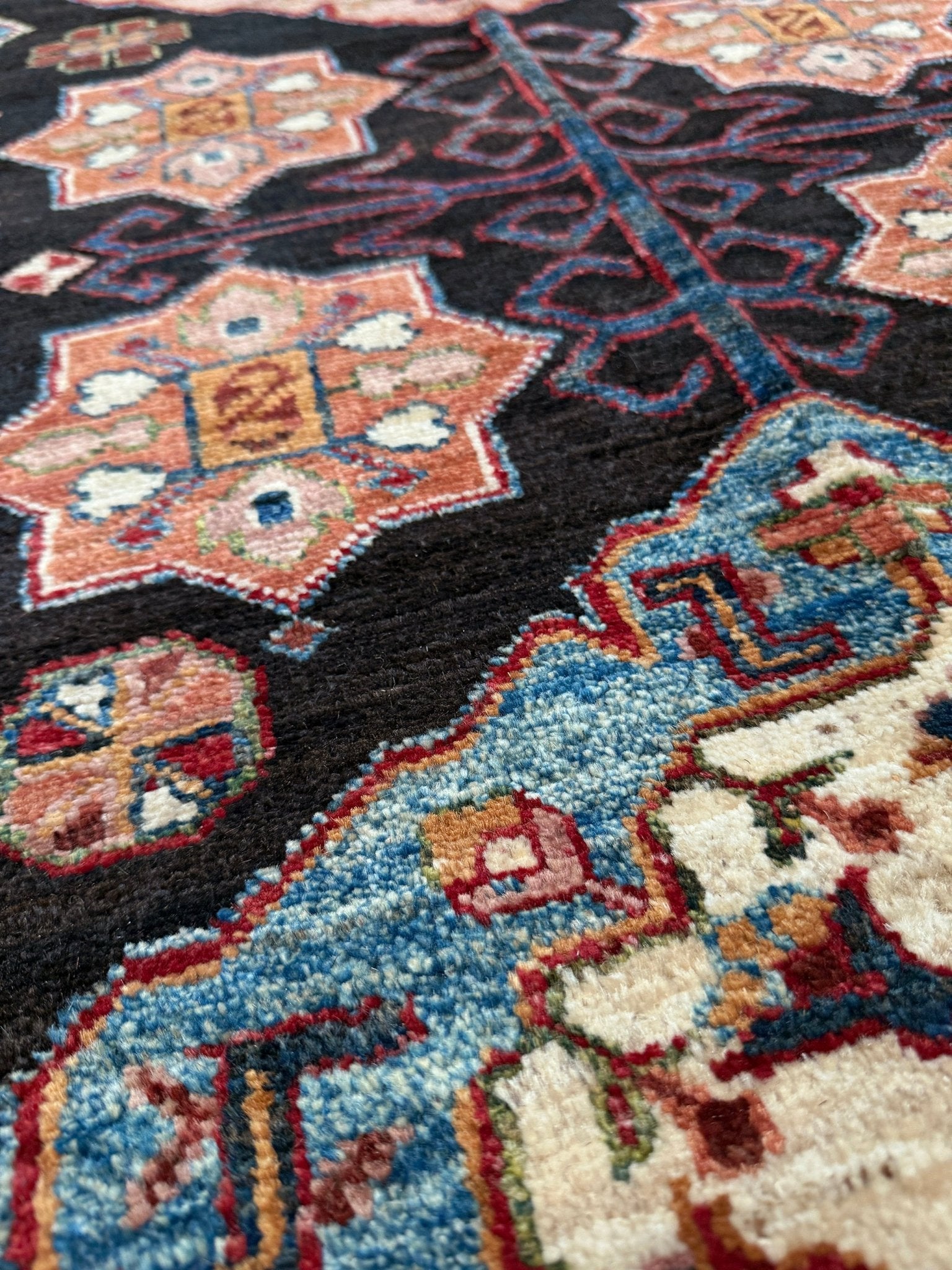 Handmade Turkmen-style 9x12 wool rug with Caucasian-inspired design, rich black, crimson, ivory, and sage hues. Luxury area rug with intricate medallions and floral motifs, perfect for bedroom, living room, or dining room. High-quality craftsmanship from the best rug shop in Burlingame CA, SF Bay Area. Free shipping, timeless character, and elegance for any space.