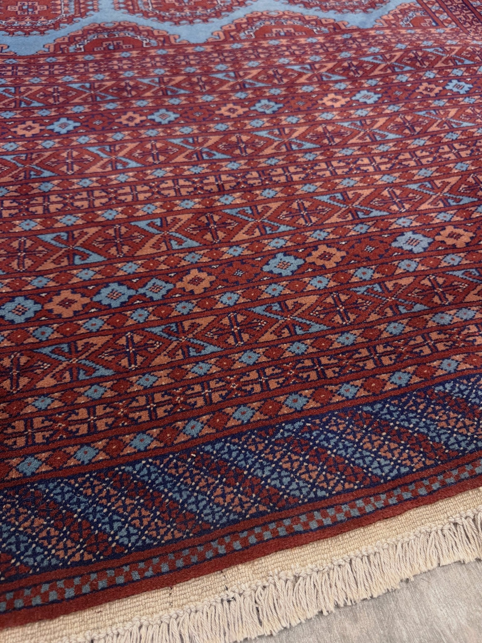 Vintage Uzbek Bukhara rug with sky blue field and repeating brick red gul motifs, navy borders, large handmade merino wool area rug 10x14 with velvety pile from Indigo Rugs Burlingame Bay Area