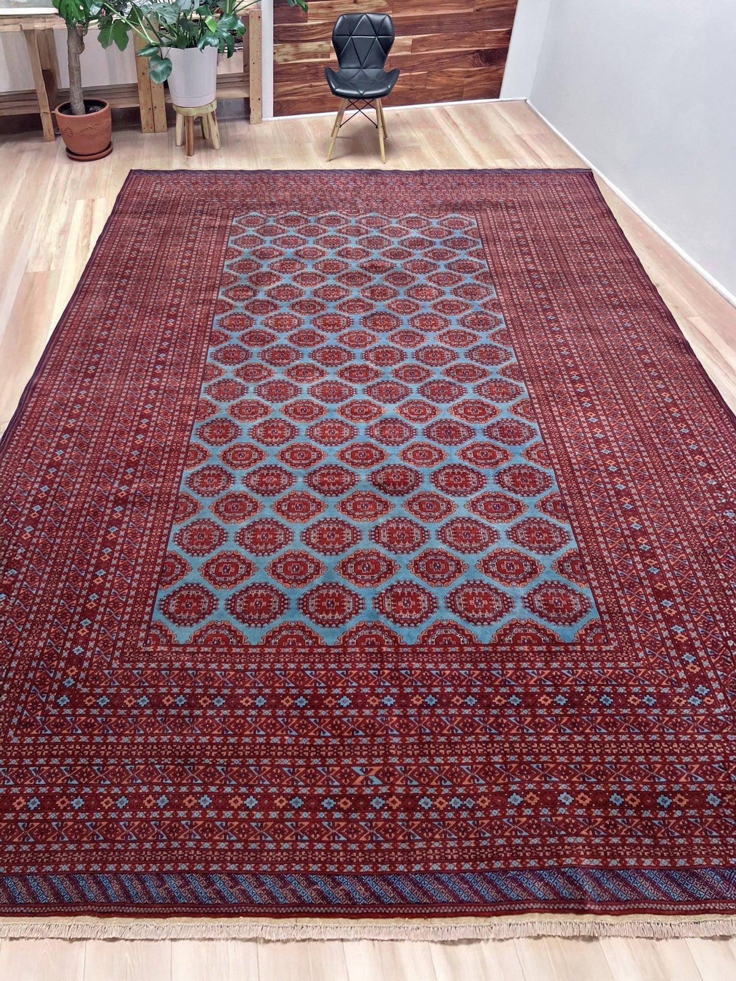 Vintage Uzbek Bukhara rug with sky blue field and repeating brick red gul motifs, navy borders, large handmade merino wool area rug 10x14 with velvety pile from Indigo Rugs Burlingame Bay Area