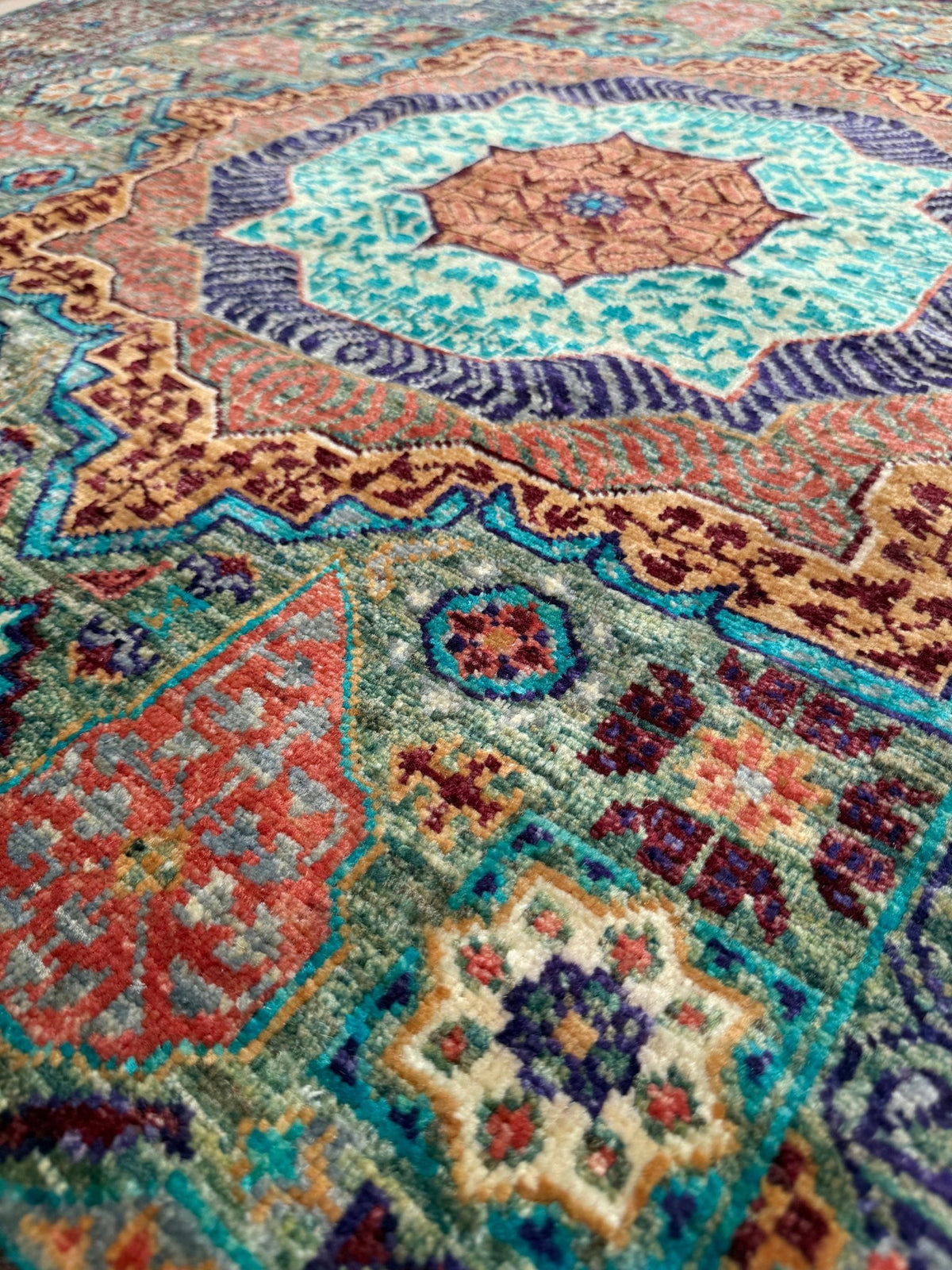 Handmade 6x8 Mamluk rug with a sage green field with terracotta, turquoise, navy, coral, and plum motifs, perfect for living room, bedroom, kitchen, or dining room. The best rug shop in Burlingame, SF Bay Area.