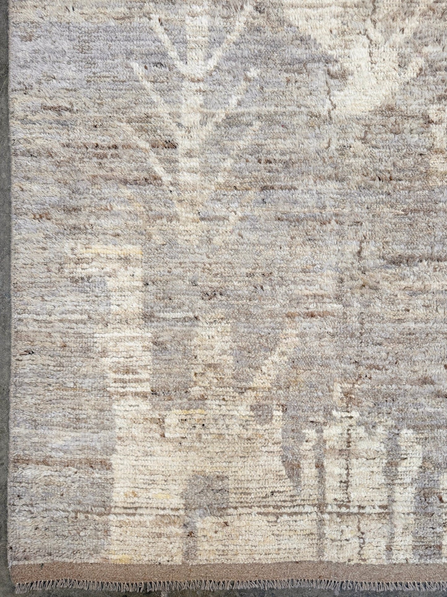 Textured area rug with a neutral color palette. Brand new 9x12 Turkish Tulu Organic Modern  rug with warm greige field, soft ivory abstract tribal motifs, taupe and oatmeal tones, handmade wool area rug from Indigo Rugs Burlingame Bay Area.