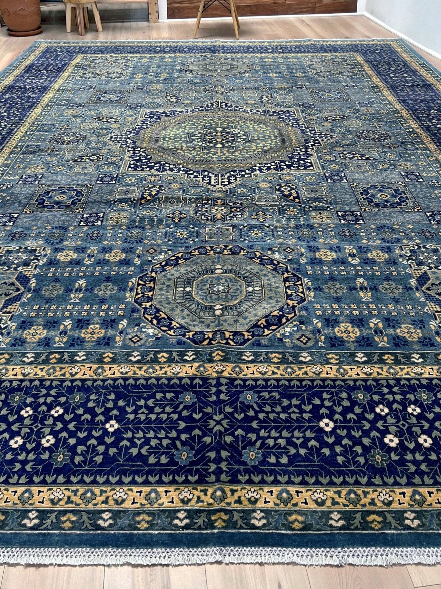 Decorative blue rug with intricate patterns. Brand new fine Mamluk rug 10x14 with navy, denim blue, and soft gold geometric medallion design, high knot density (50×50 ~156 KPSI), perfect for large living rooms and dining spaces. From Indigo Rugs, Burlingame — the best rug shop in the San Francisco Bay Area. Free shipping.