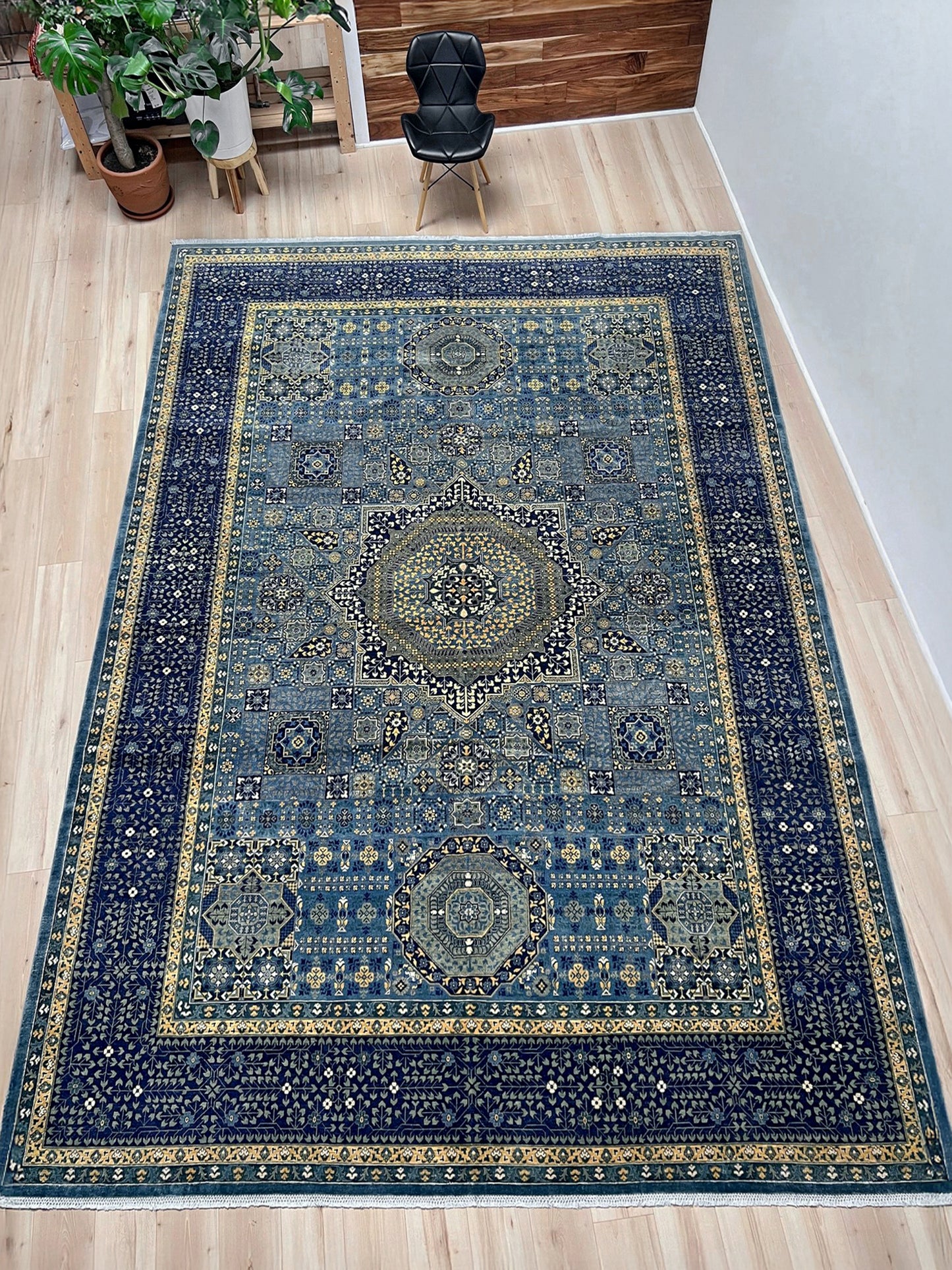Decorative blue rug with intricate patterns on a wooden floor. Brand new fine Mamluk rug 10x14 with navy, denim blue, and soft gold geometric medallion design, high knot density (50×50 ~156 KPSI), perfect for large living rooms and dining spaces. From Indigo Rugs, Burlingame — the best rug shop in the San Francisco Bay Area. Free shipping.
