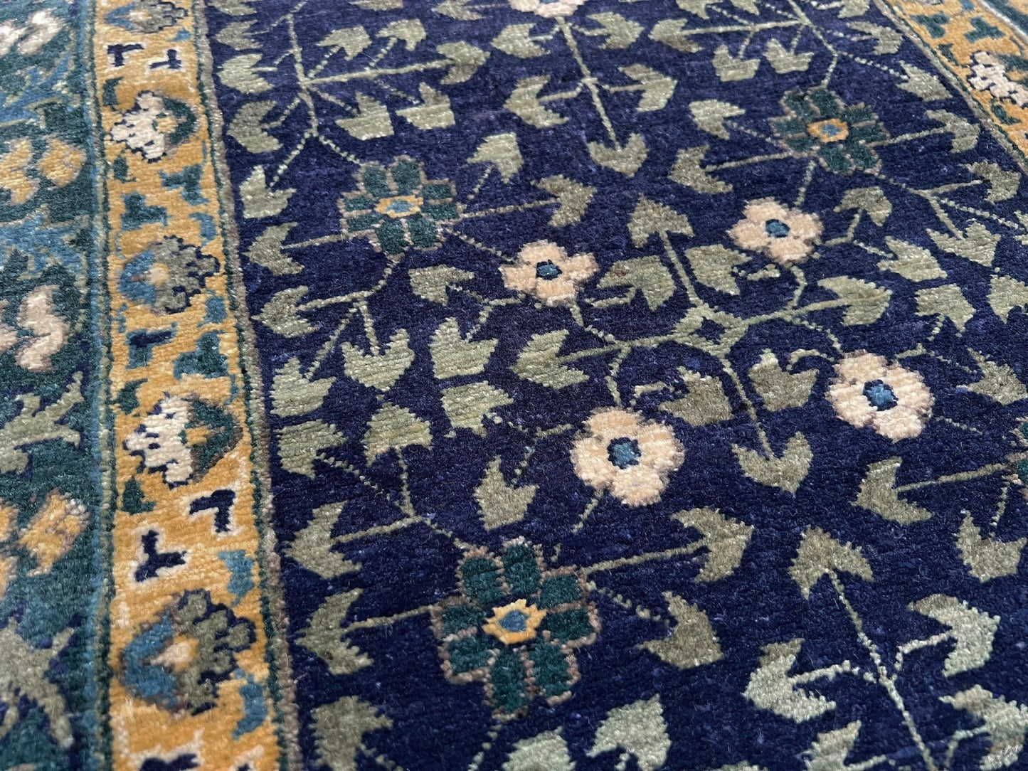 Decorative blue and gold rug with intricate patterns on a wooden floor. Brand new fine Mamluk rug 10x14 with navy, denim blue, and soft gold geometric medallion design, high knot density (50×50 ~156 KPSI), perfect for large living rooms and dining spaces. From Indigo Rugs, Burlingame — the best rug shop in the San Francisco Bay Area. Free shipping.