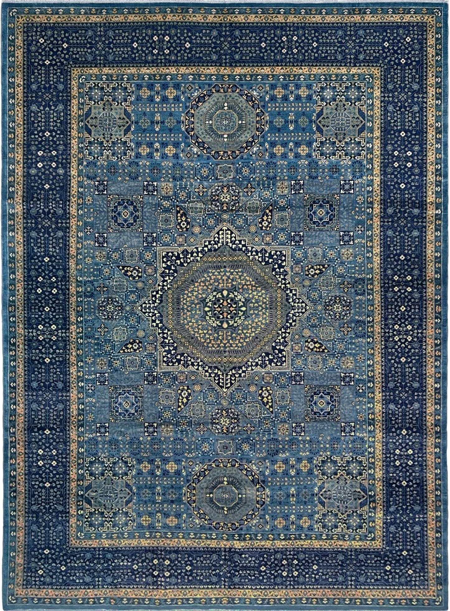 Decorative blue rug with intricate patterns. Brand new fine Mamluk rug 10x14 with navy, denim blue, and soft gold geometric medallion design, high knot density (50×50 ~156 KPSI), perfect for large living rooms and dining spaces. From Indigo Rugs, Burlingame — the best rug shop in the San Francisco Bay Area. Free shipping.