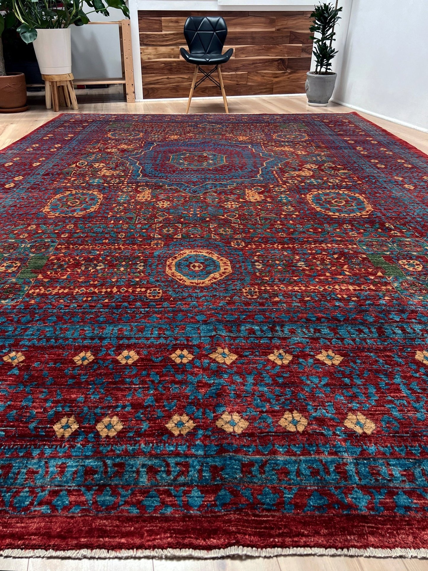 Regal Mamluk area rug made from luxurious Ghazni wool, featuring a rich color combination of deep reds, blues, golds, and greens. This handmade carpet showcases intricate geometric patterns and medallions, adding elegance and sophistication to any living room, bedroom, dining area, or office. Available from the best rug shop in the San Francisco Bay Area, this luxury rug comes with free shipping across the U.S.