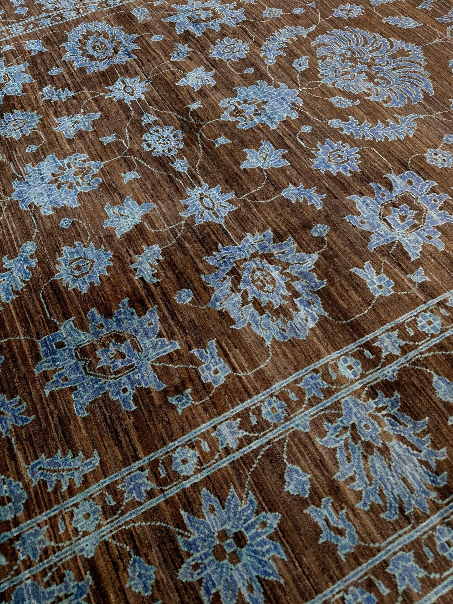Brand new handmade floral rug with walnut brown, blue and soft turquoise accents, wool area rug 7x9 from Indigo Rugs Burlingame Bay Area.