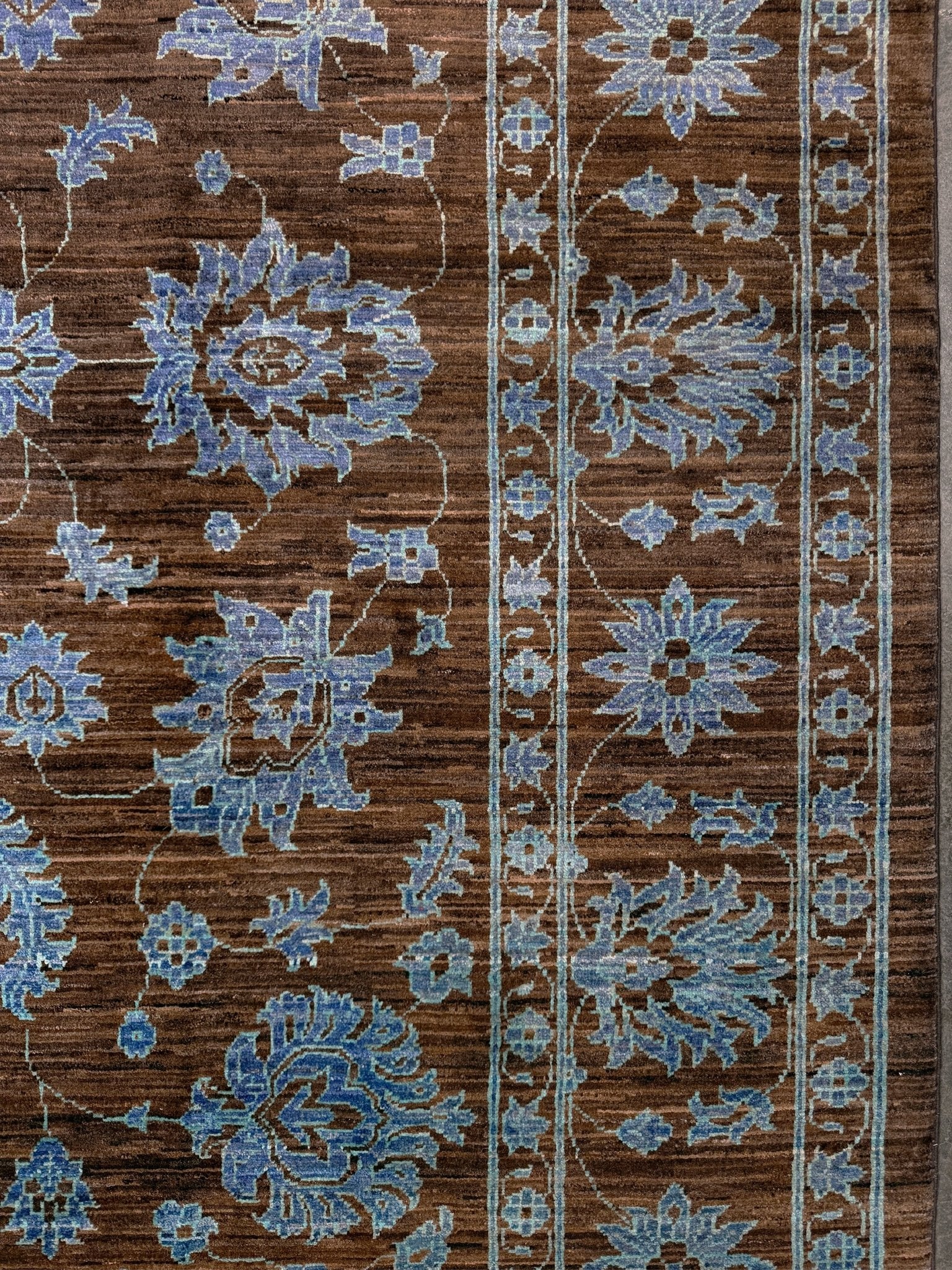 Brand new handmade floral rug with walnut brown, blue and soft turquoise accents, wool area rug 7x9 from Indigo Rugs Burlingame Bay Area.