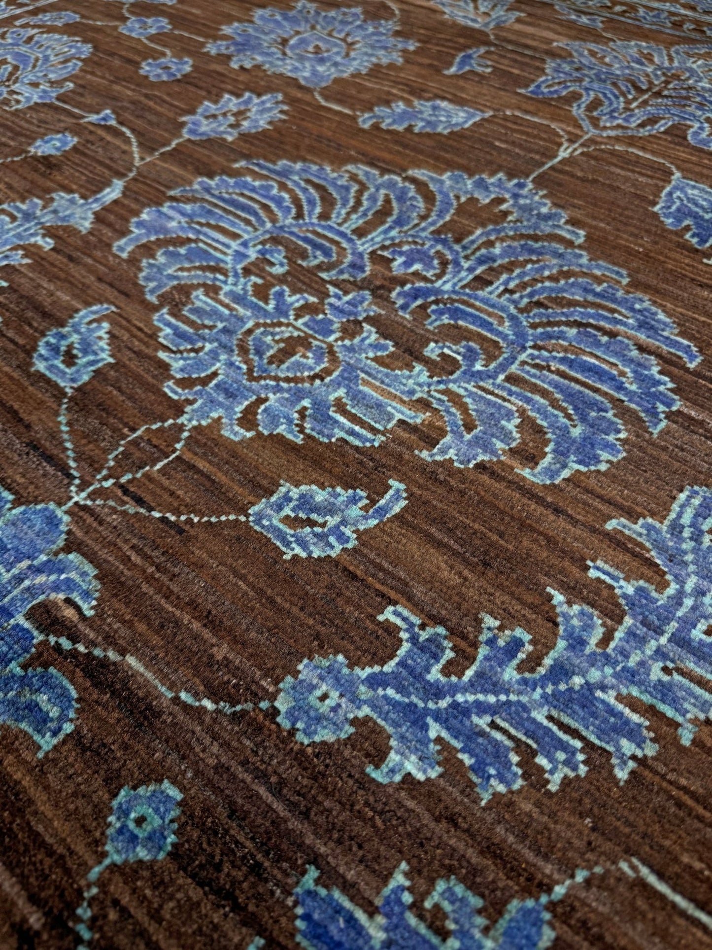 Brand new handmade floral rug with walnut brown, blue and soft turquoise accents, wool area rug 7x9 from Indigo Rugs Burlingame Bay Area.