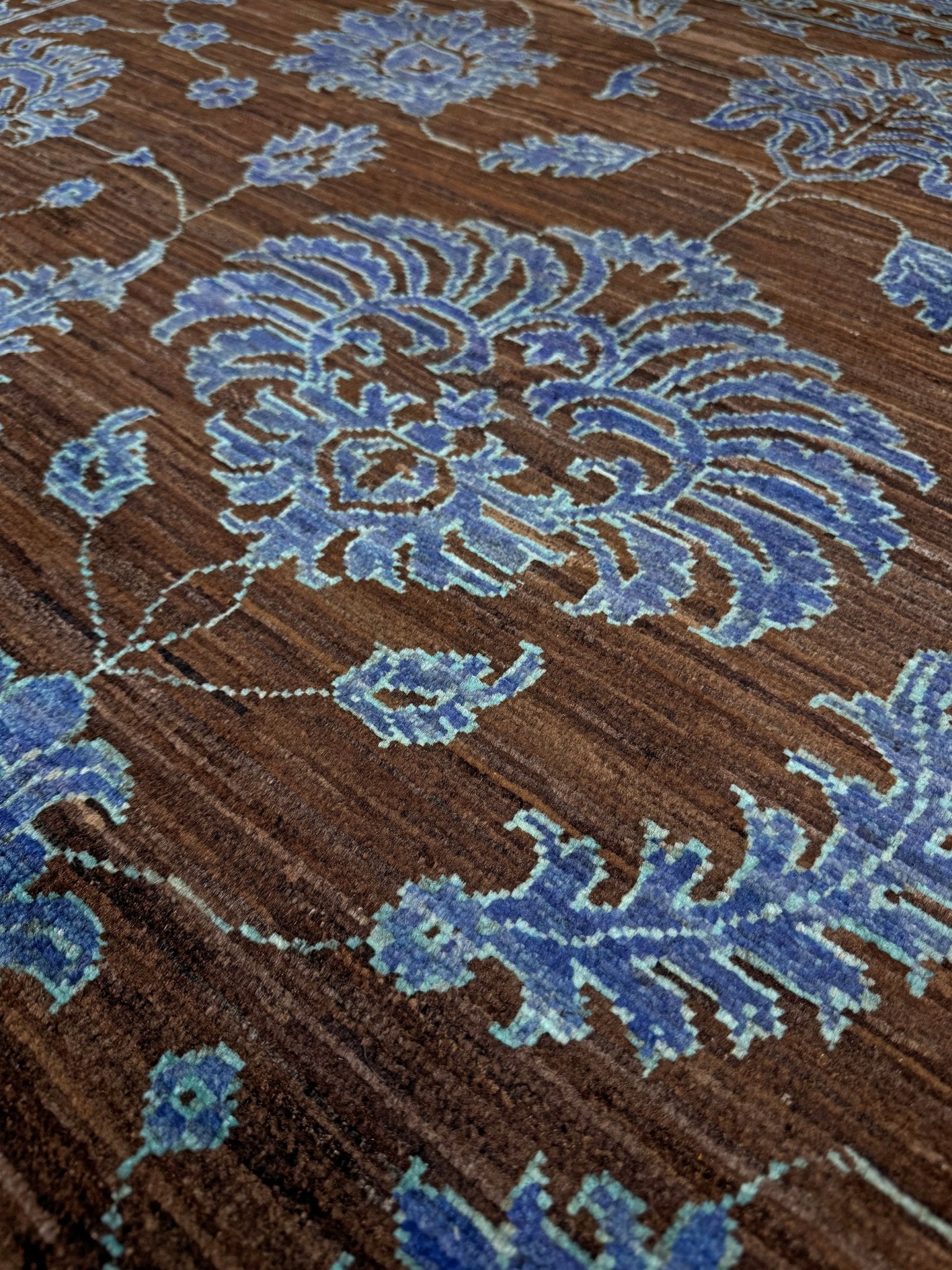 Brand new handmade floral rug with walnut brown, blue and soft turquoise accents, wool area rug 7x9 from Indigo Rugs Burlingame Bay Area.