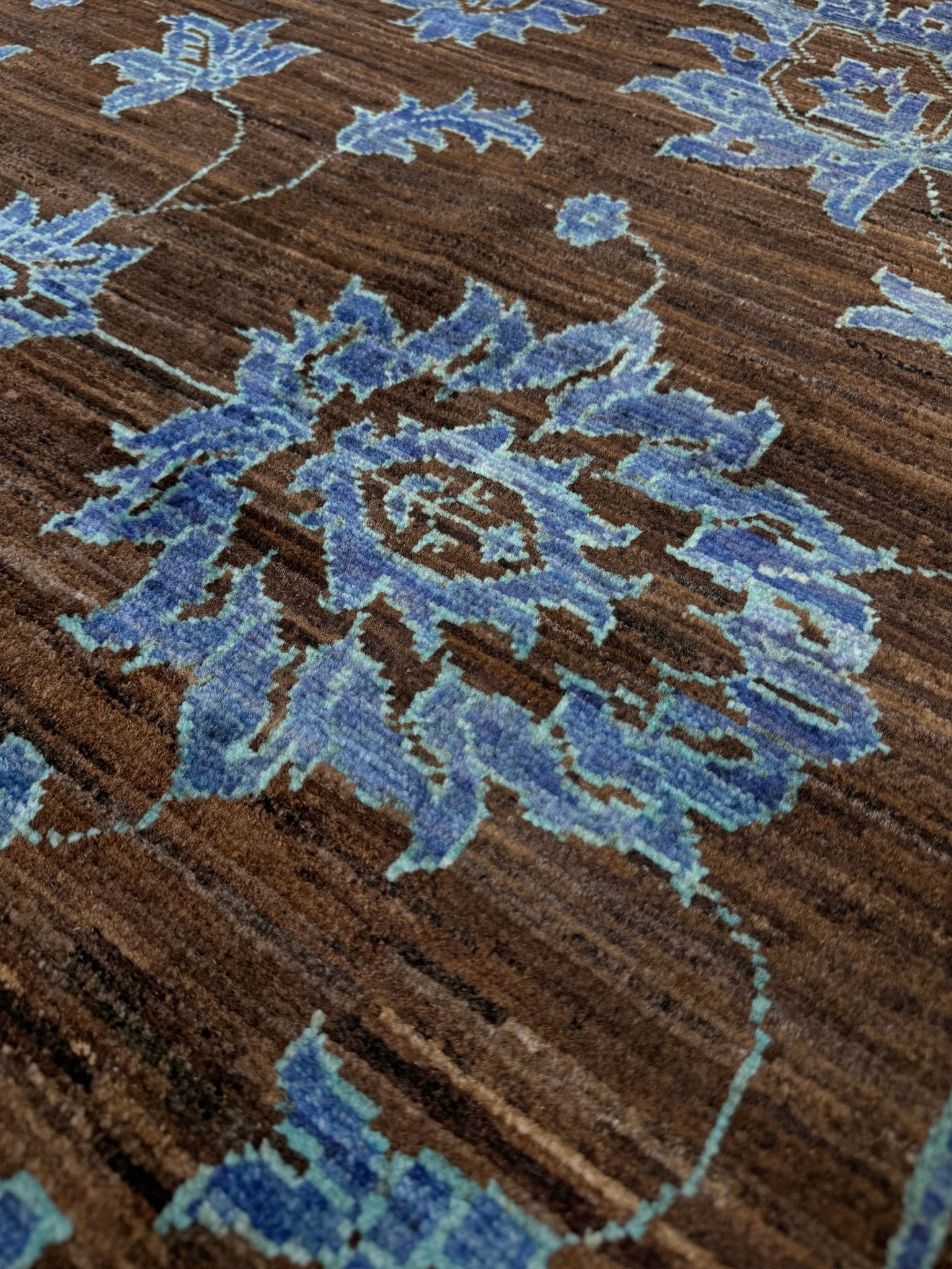Brand new handmade floral rug with walnut brown, blue and soft turquoise accents, wool area rug 7x9 from Indigo Rugs Burlingame Bay Area.