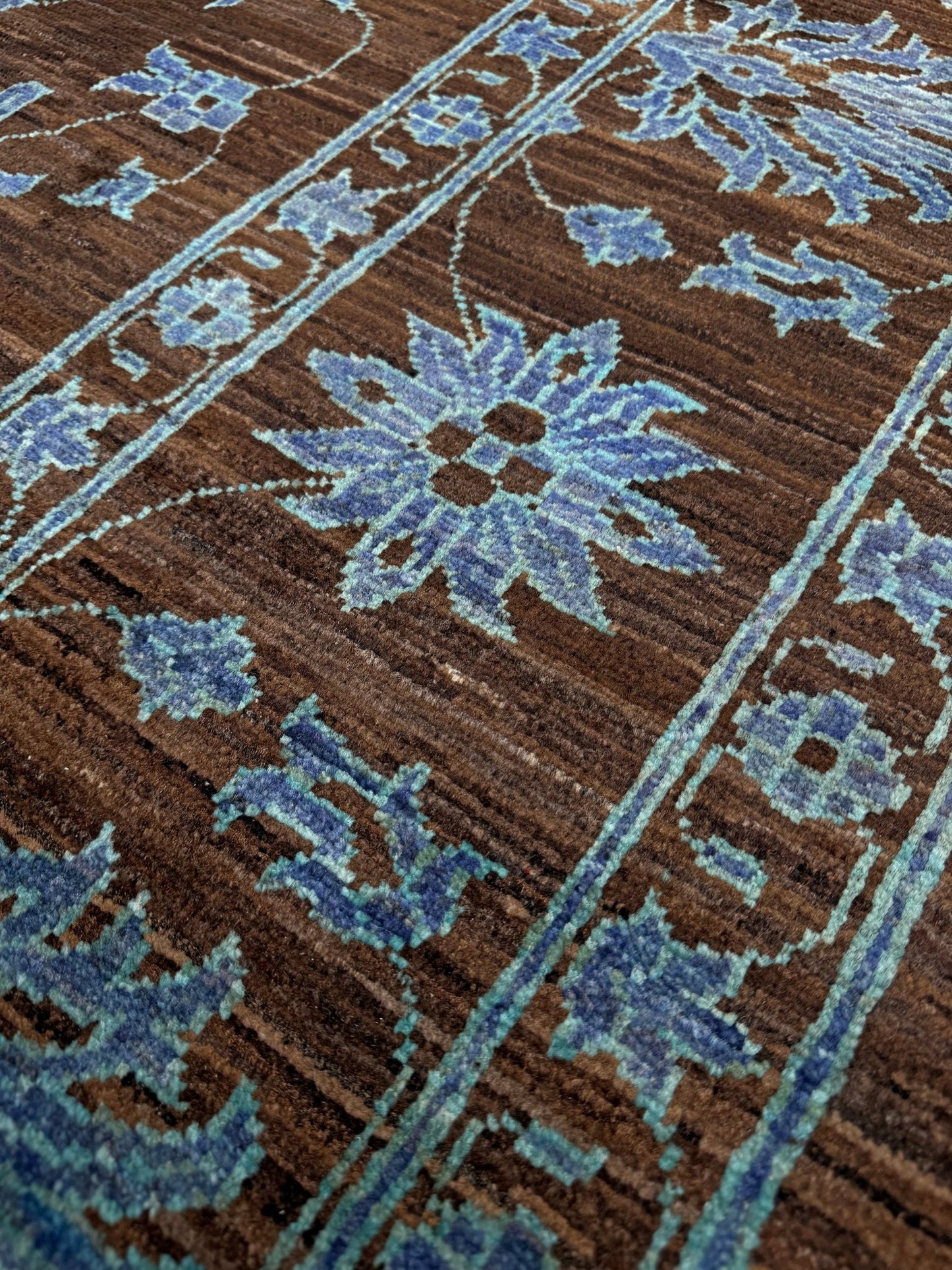 Brand new handmade floral rug with walnut brown, blue and soft turquoise accents, wool area rug 7x9 from Indigo Rugs Burlingame Bay Area.