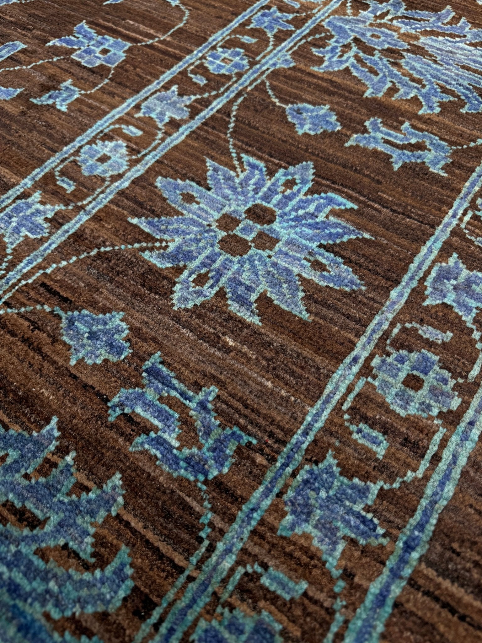 Brand new handmade floral rug with walnut brown, blue and soft turquoise accents, wool area rug 7x9 from Indigo Rugs Burlingame Bay Area.