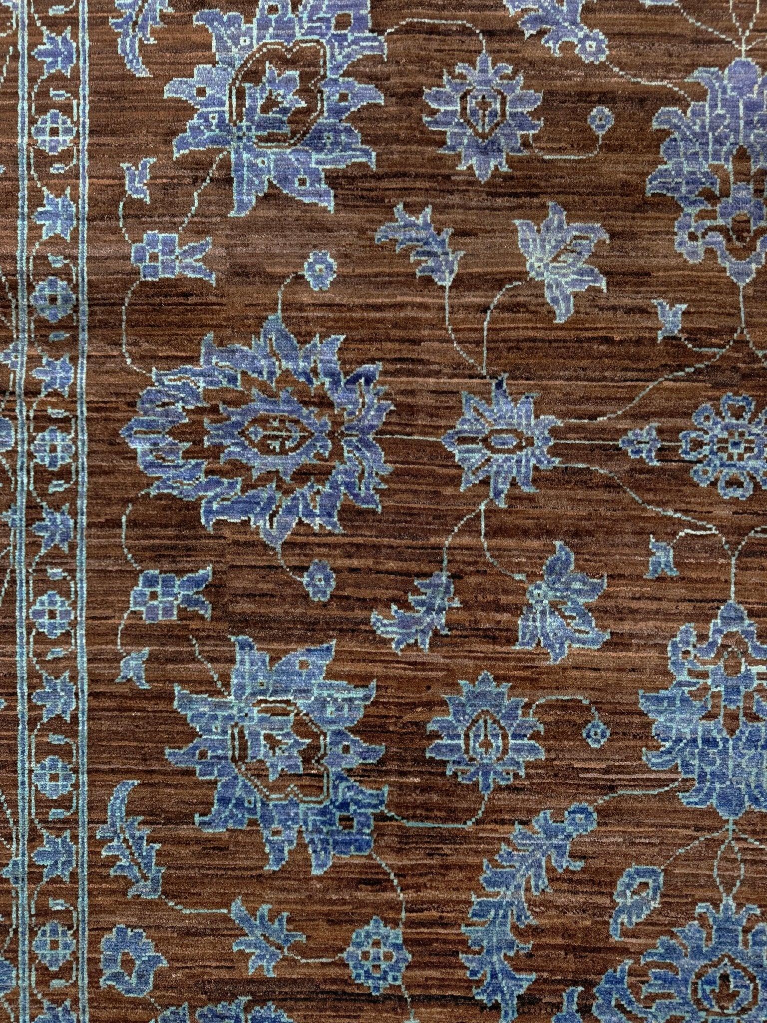 Brand new handmade floral rug with walnut brown, blue and soft turquoise accents, wool area rug 7x9 from Indigo Rugs Burlingame Bay Area.
