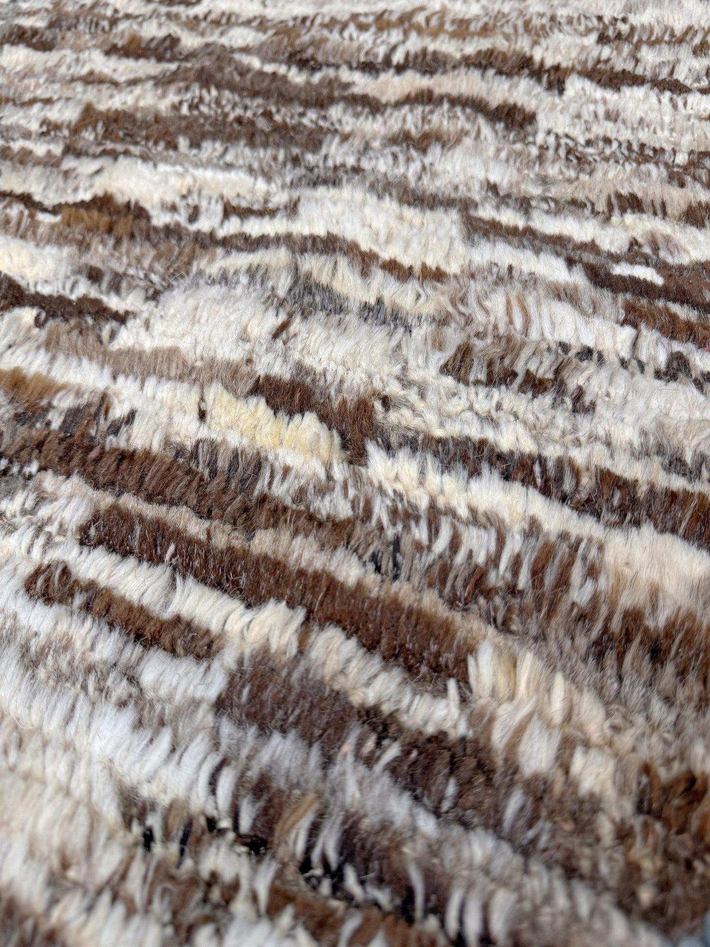 Close-up of a textured brown and beige rug. Square 9x10 handmade Turkish Tulu rug with ivory and brown textured wool pile, subtle diamond lattice design — shown at Indigo Rugs, Burlingame — San Francisco Bay Area with free shipping