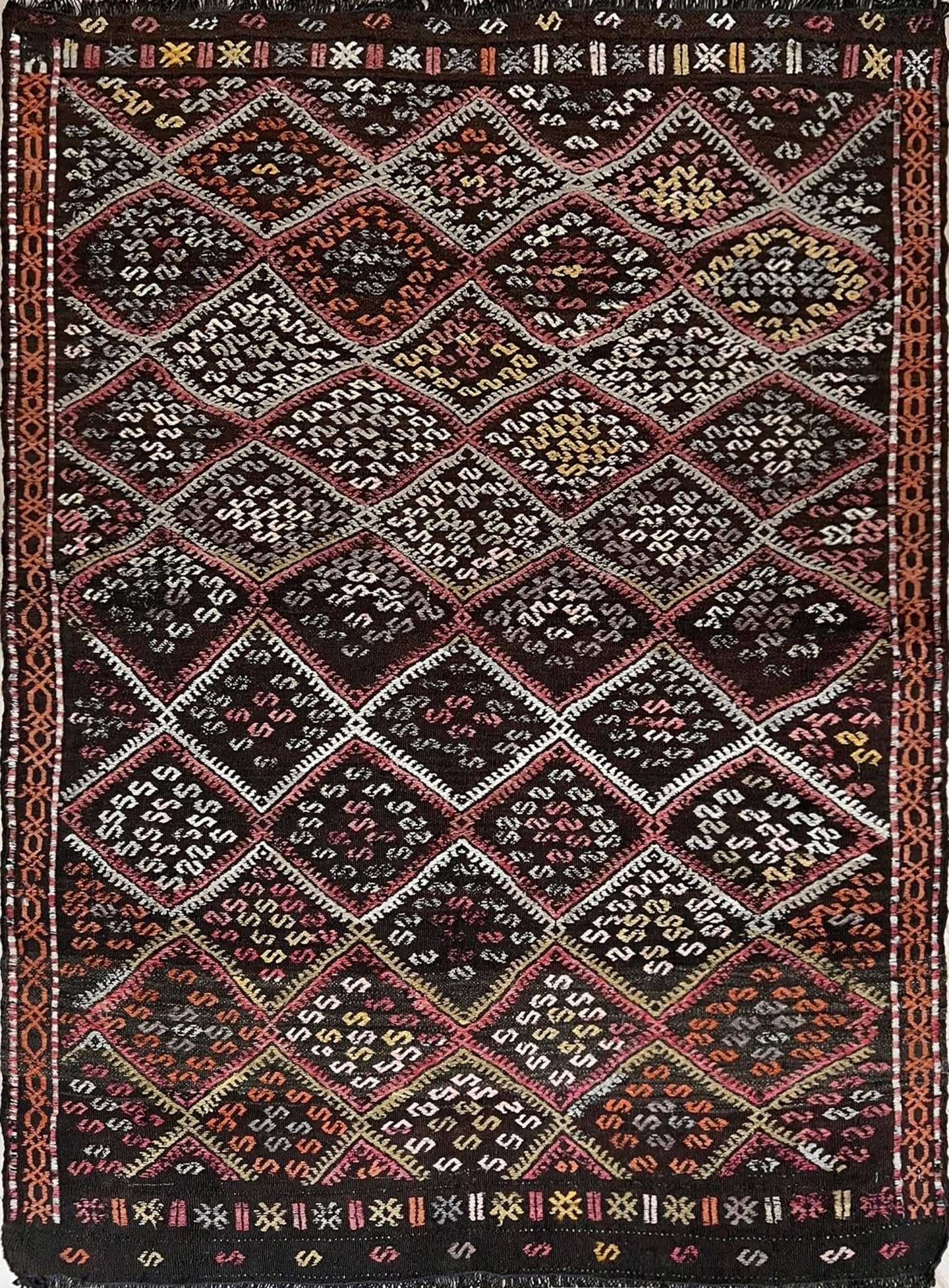 Vintage Malatya Cicim Turkish kilim rug with embroidered diamond motifs in rose, amber, and ivory on a charcoal brown field — handmade wool flatweave from the 1940s, available at Indigo Rugs, the best rug shop in San Francisco Bay Area, Burlingame CA.