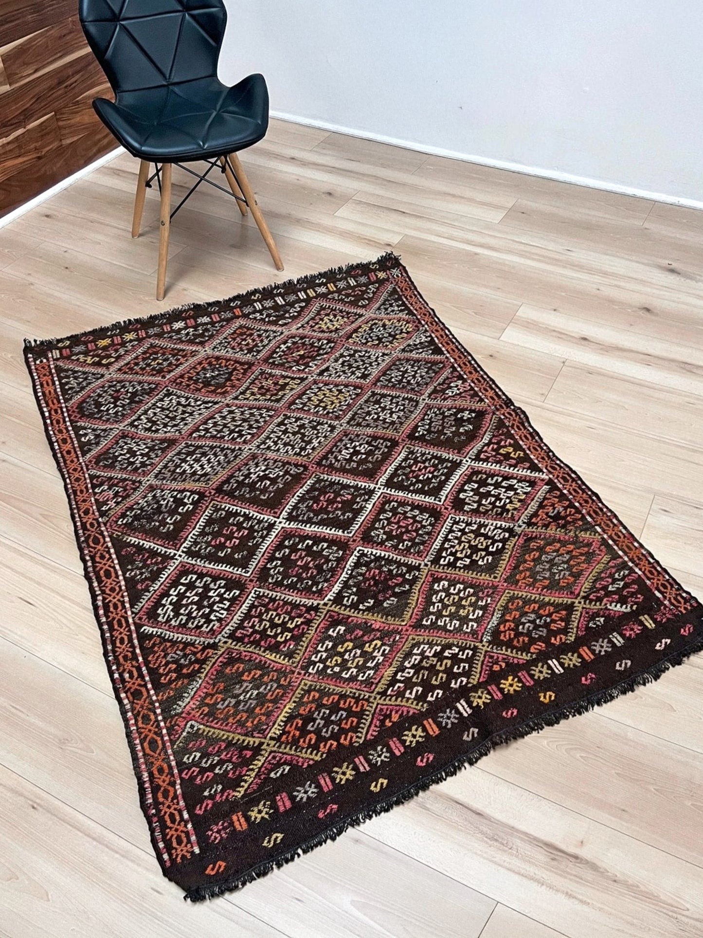 Vintage Malatya Cicim Turkish kilim rug with embroidered diamond motifs in rose, amber, and ivory on a charcoal brown field — handmade wool flatweave from the 1940s, available at Indigo Rugs, the best rug shop in San Francisco Bay Area, Burlingame CA.