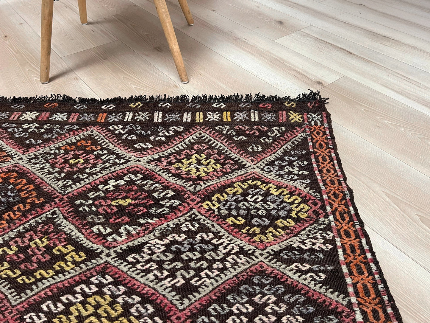 4x6 Vintage Malatya Cicim Turkish kilim rug with embroidered diamond motifs in rose, amber, and ivory on a charcoal brown field — handmade wool flatweave from the 1940s, available at Indigo Rugs, the best rug shop in San Francisco Bay Area, Burlingame CA.