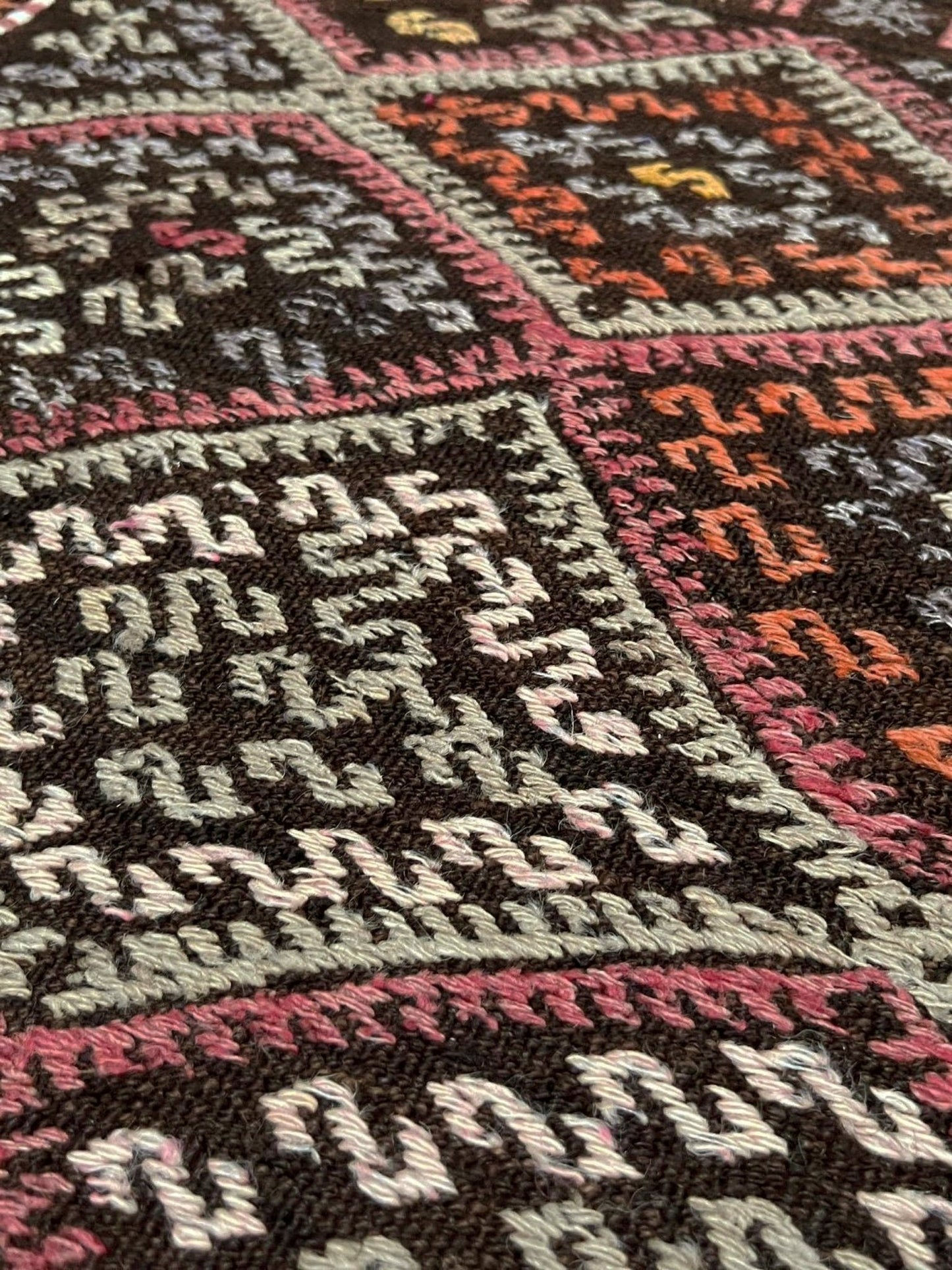 Vintage Turkish cicim kilim rug, approx. 4x6, with deep espresso brown field and diamond motifs in dusty rose, amber, soft terracotta, muted olive green, ivory, and subtle mauve tones. Handwoven wool flatweave from Indigo Rugs, Burlingame — San Francisco Bay Area.