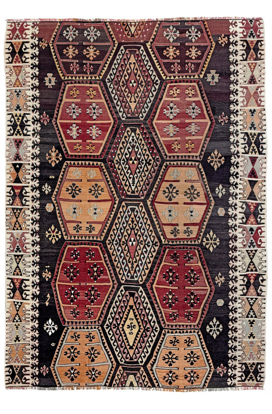 Decorative rug with geometric pattern on a white background. Vintage Sarkisla Turkish kilim rug 6x9 with deep brown field and geometric medallions in madder red, camel, and ivory tones — handmade Anatolian flatweave carpet
