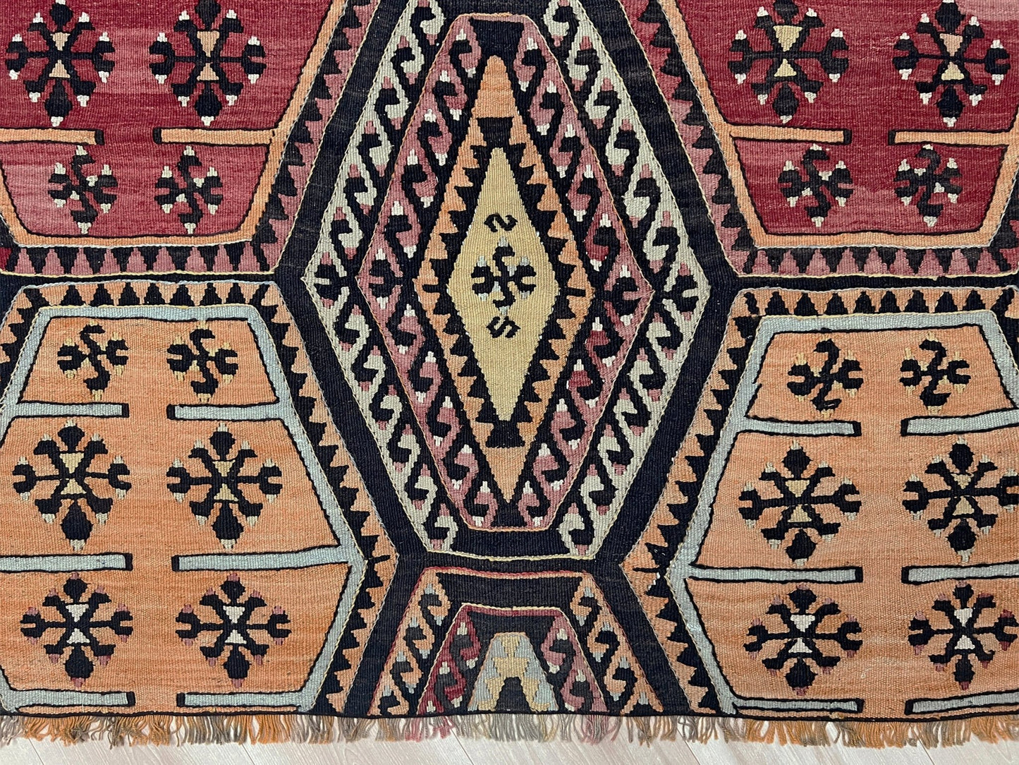 Vintage Sarkisla Turkish kilim rug 6x9 with deep brown field and geometric medallions in madder red, camel, and ivory tones — handmade Anatolian flatweave carpet