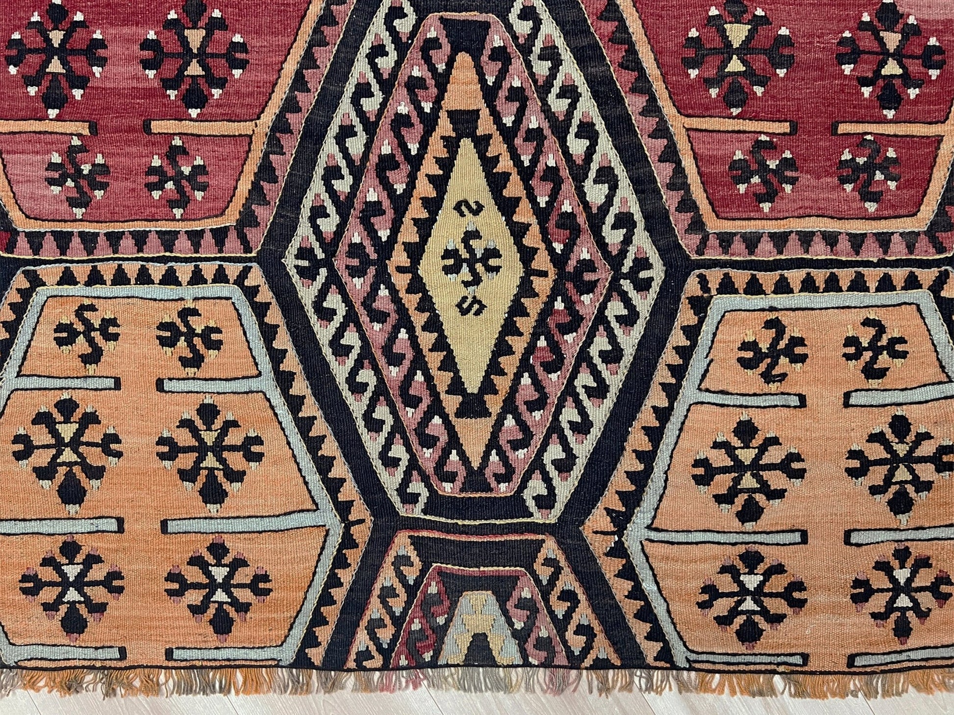 Vintage Sarkisla Turkish kilim rug 6x9 with deep brown field and geometric medallions in madder red, camel, and ivory tones — handmade Anatolian flatweave carpet