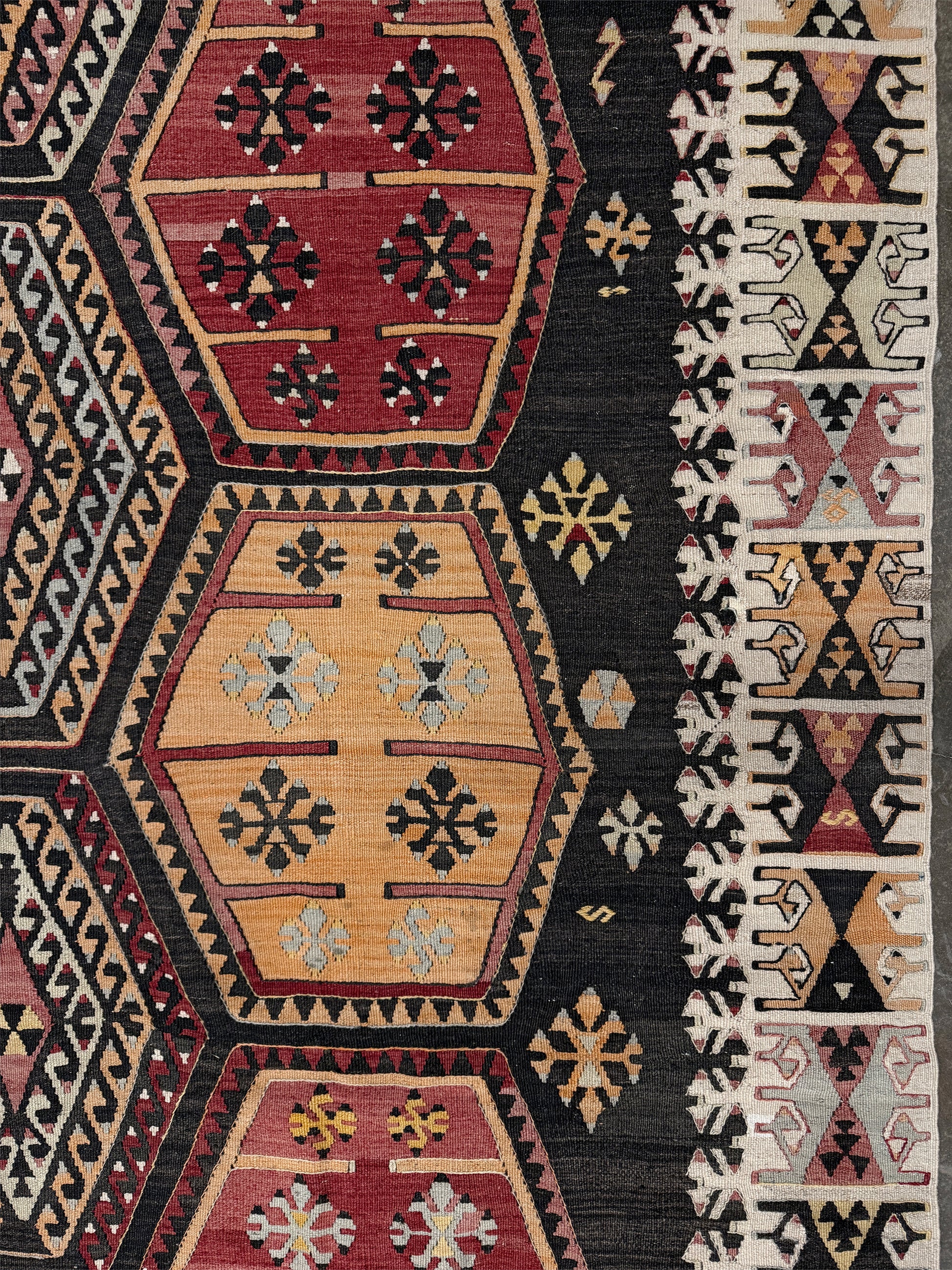 Vintage Sarkisla Turkish kilim rug 6x9 with deep brown field and geometric medallions in madder red, camel, and ivory tones — handmade Anatolian flatweave carpet