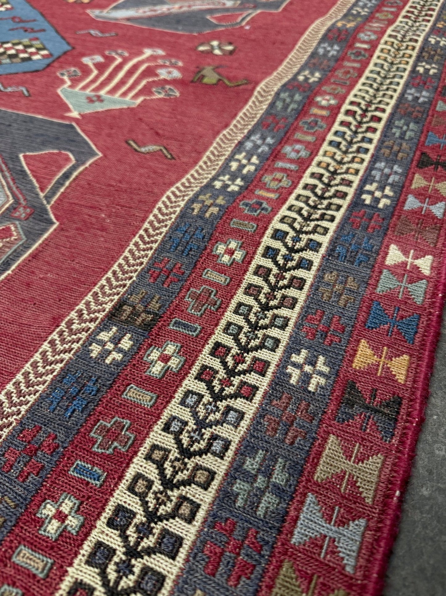 Vintage Armenian soumak rug with pictorial motifs in madder red, slate blue, ivory, and charcoal, 4x6 size.