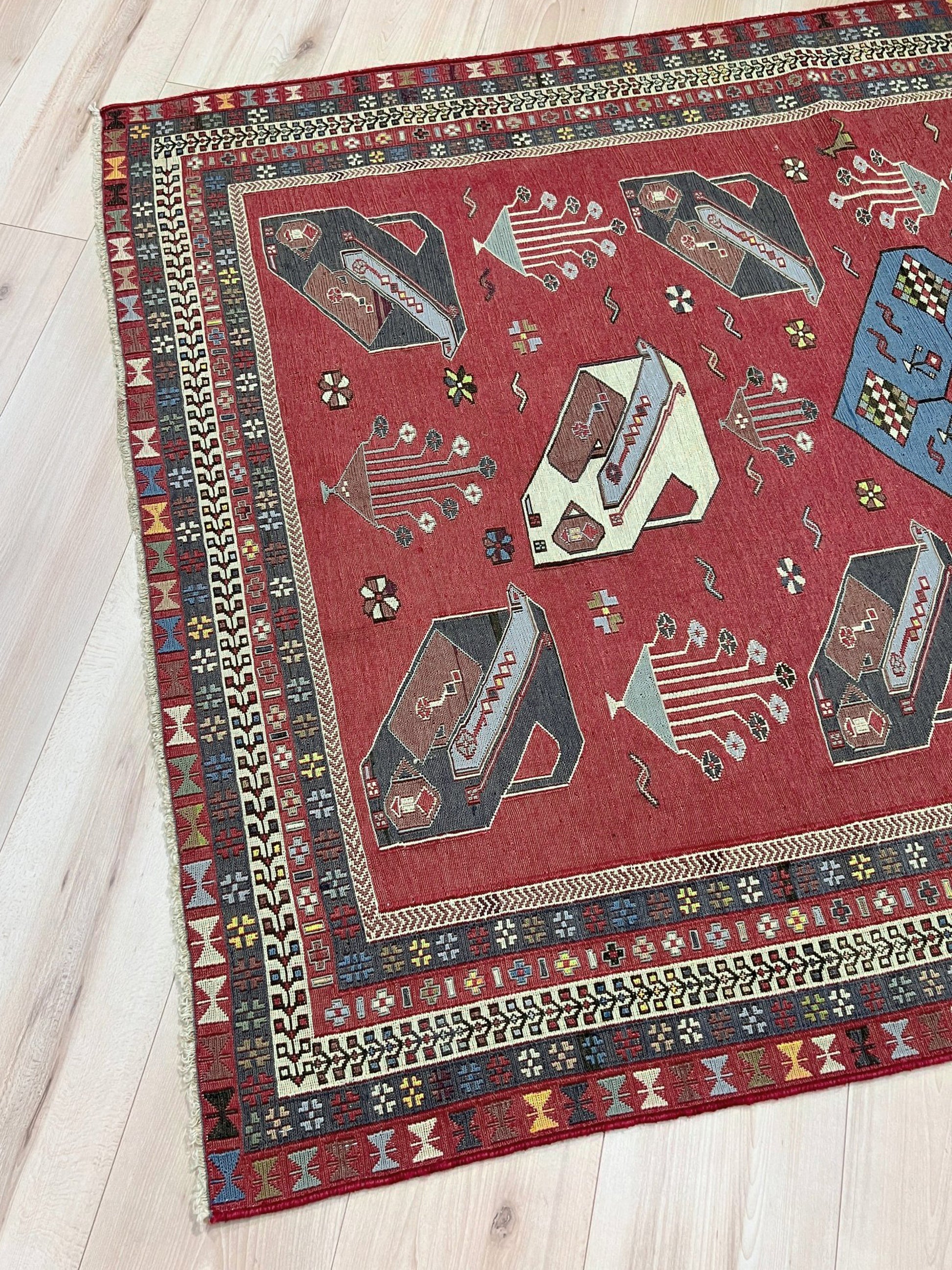 Vintage Armenian soumak rug with pictorial motifs in madder red, slate blue, ivory, and charcoal, 4x6 size.